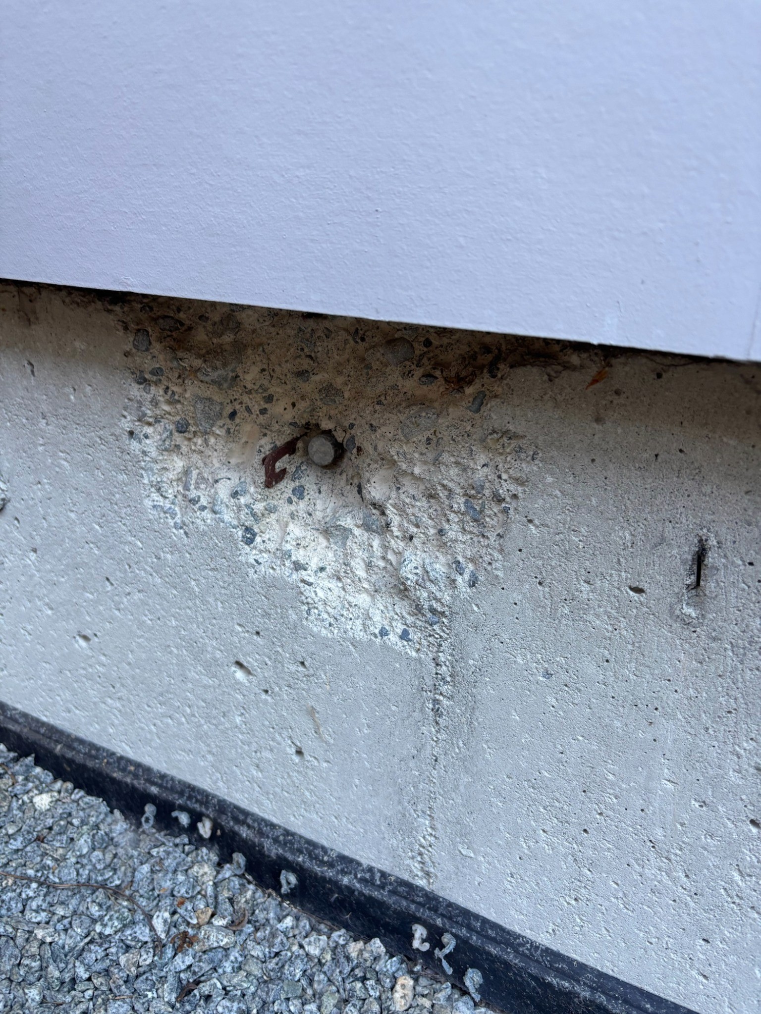Localized exterior concrete deterioration and spalling before repair.