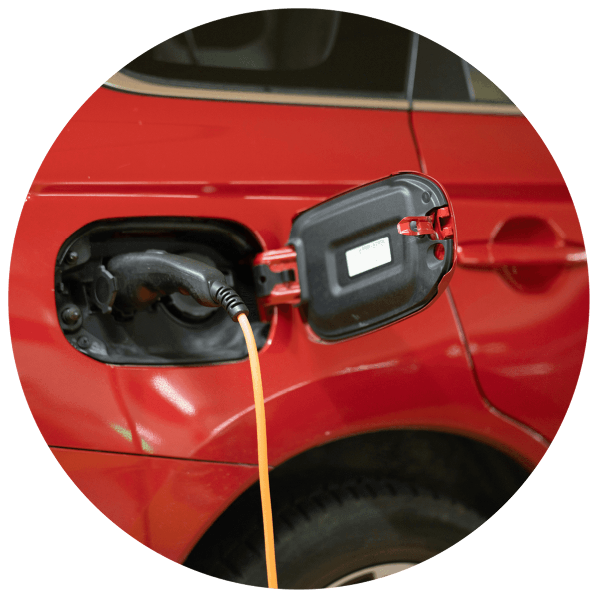 Electric car charging, bright red car with charging cable plugged in, open charging port.