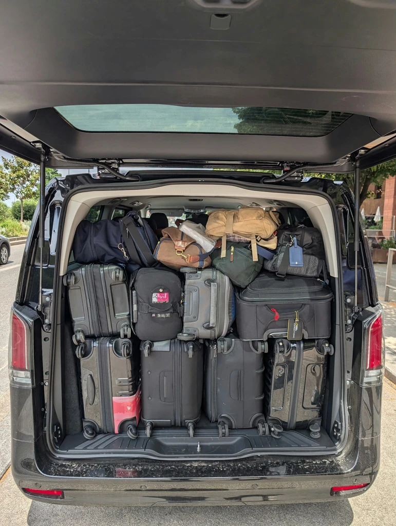Luggage packed in the rear of a private touring van