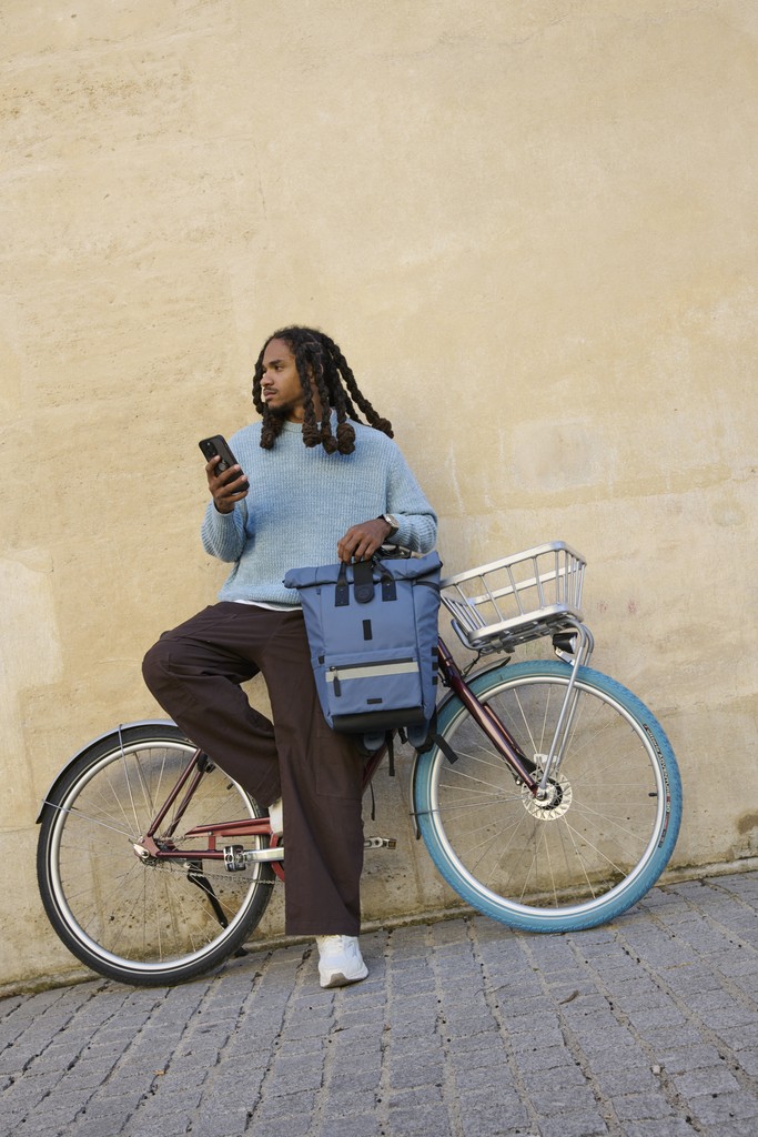 man with backpack and bike
