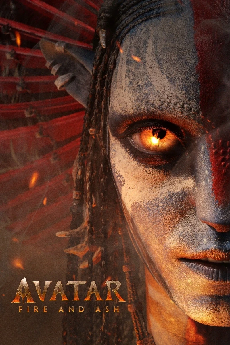 A fantasy character with intricate blue and clay-toned face paint and glowing orange eyes stands among softly glowing embers, beneath the text "Avatar: Fire and Ash" featuring an elaborate headdress with braided details.
