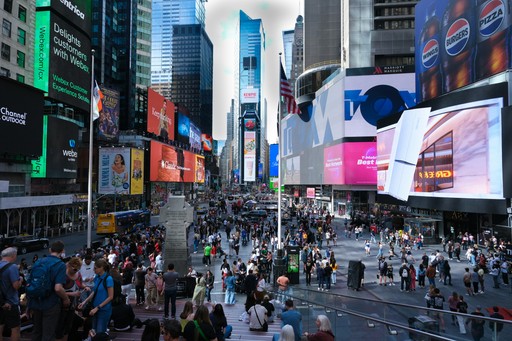 Crowded times square with bright digital billboards at night