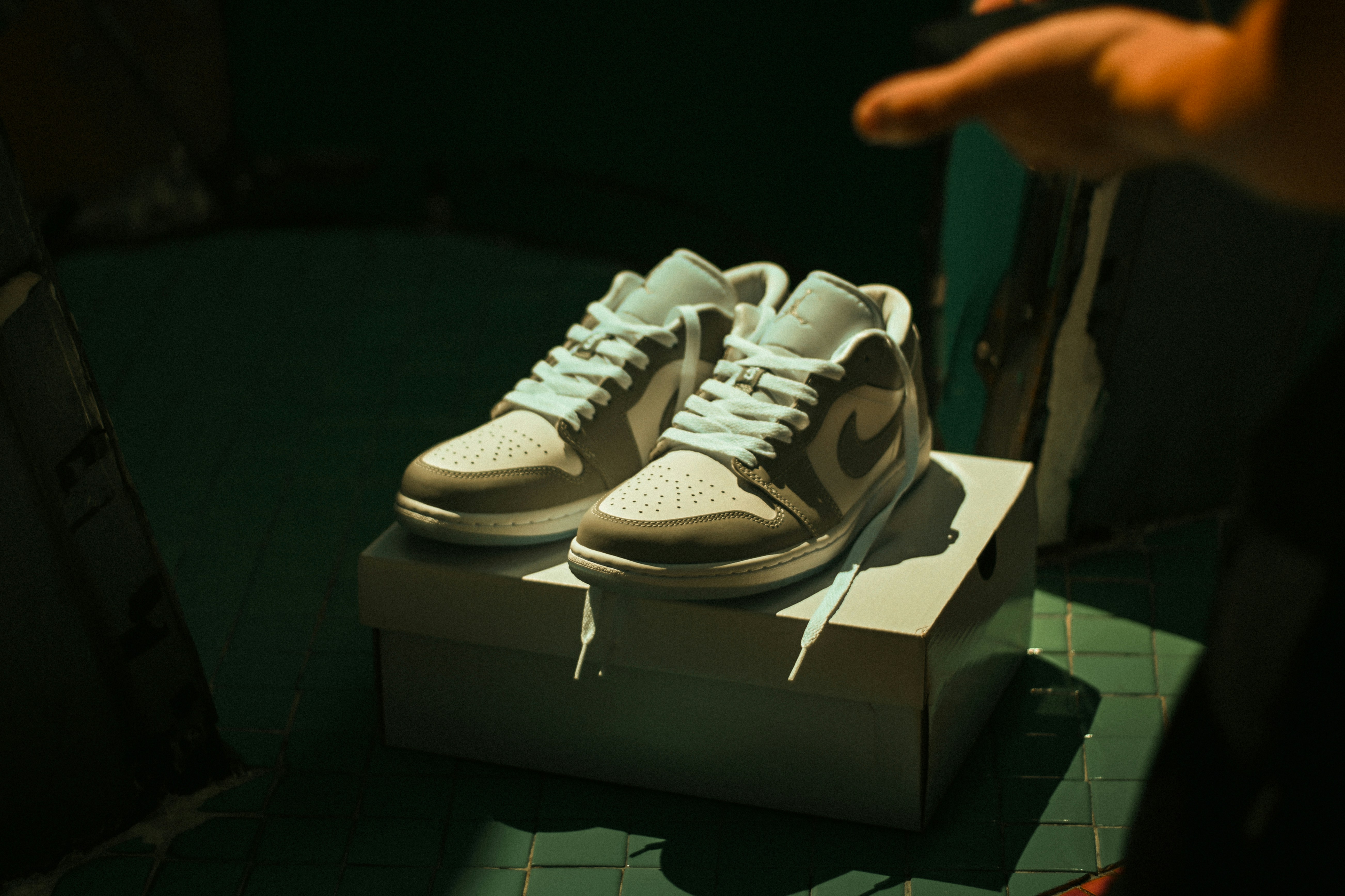 two people in a workspace working on their laptops 