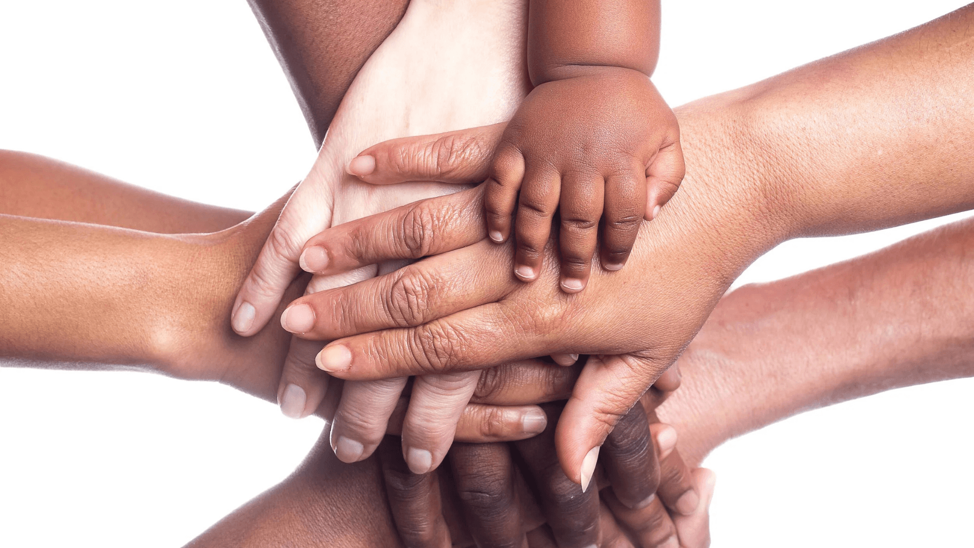Diverse group of adult and child hands stacked together