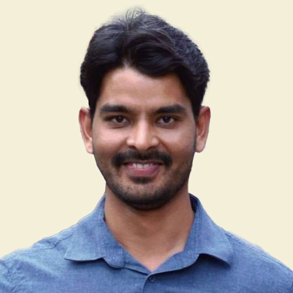 Man with arms crossed in modern office workspace.