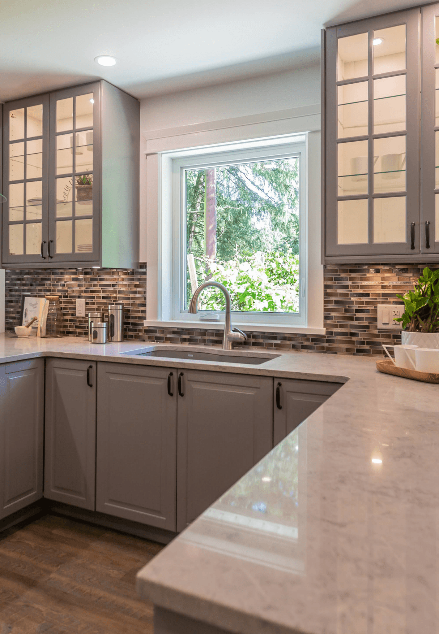 Alternate view of kitchen with natural light and classic wood cabinetry.