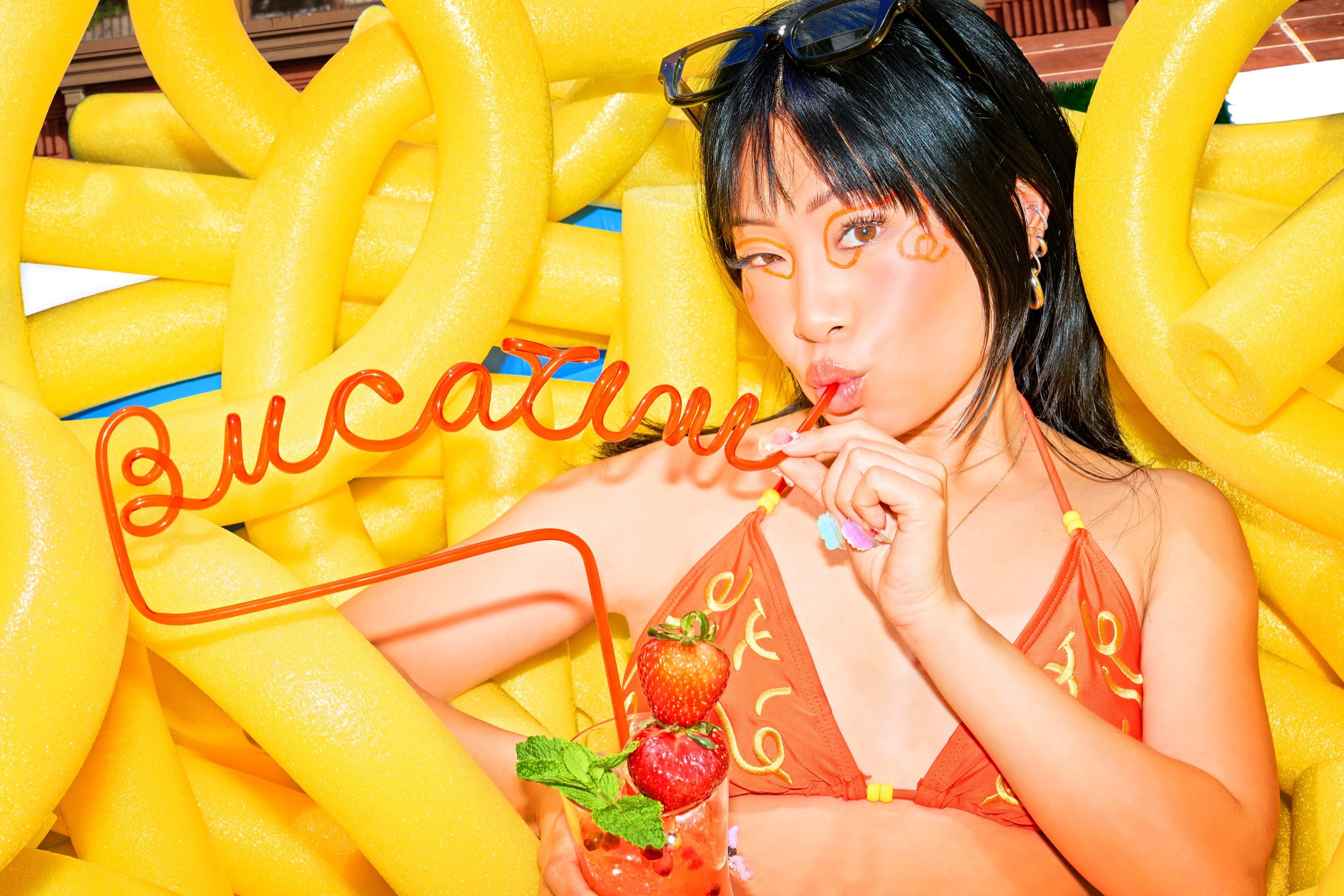 Yu Ling Wu framed by the red wire Bucakini sign