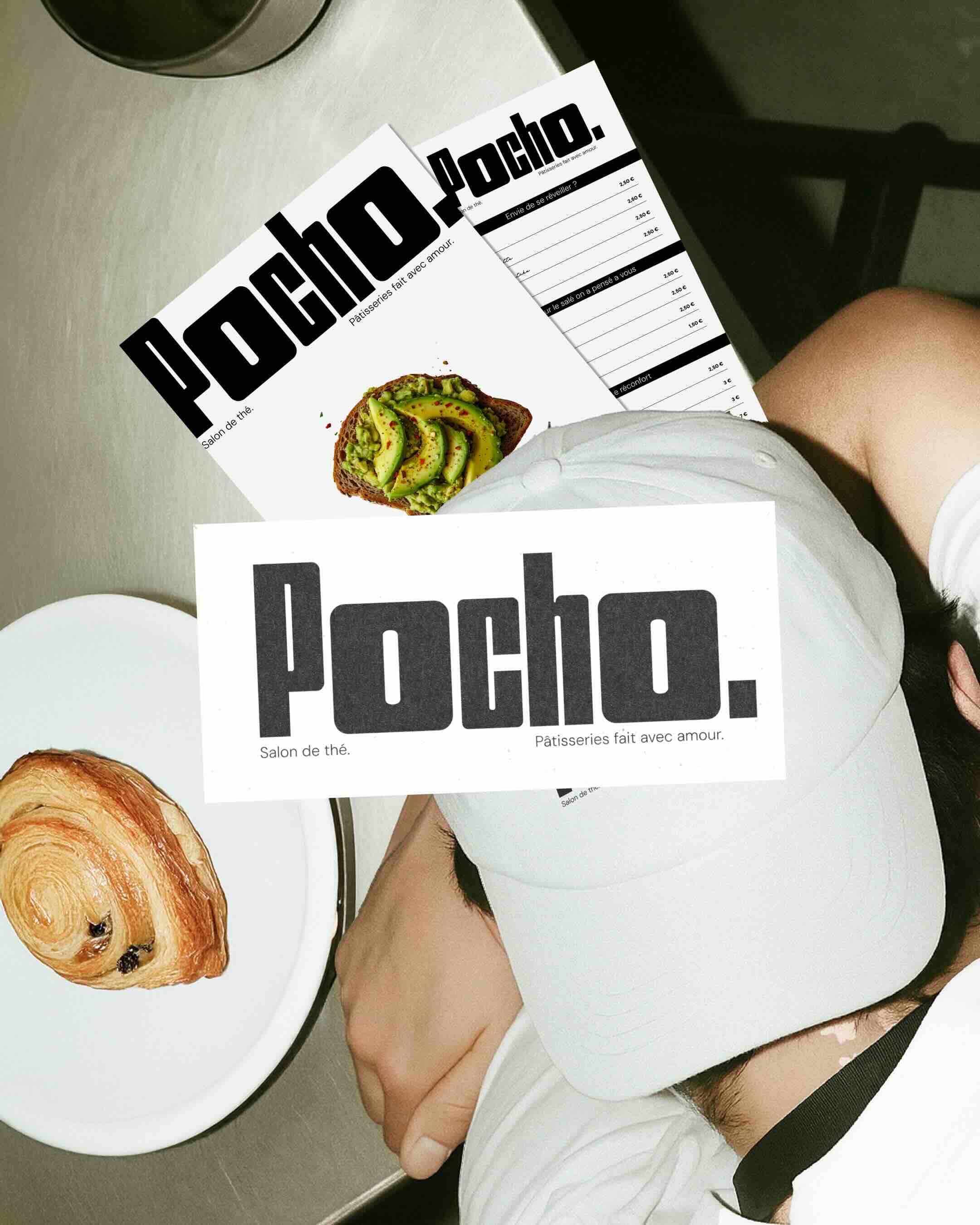 Man in a white cap and red shirt holding a golf club, looking focused against a clear blue sky.