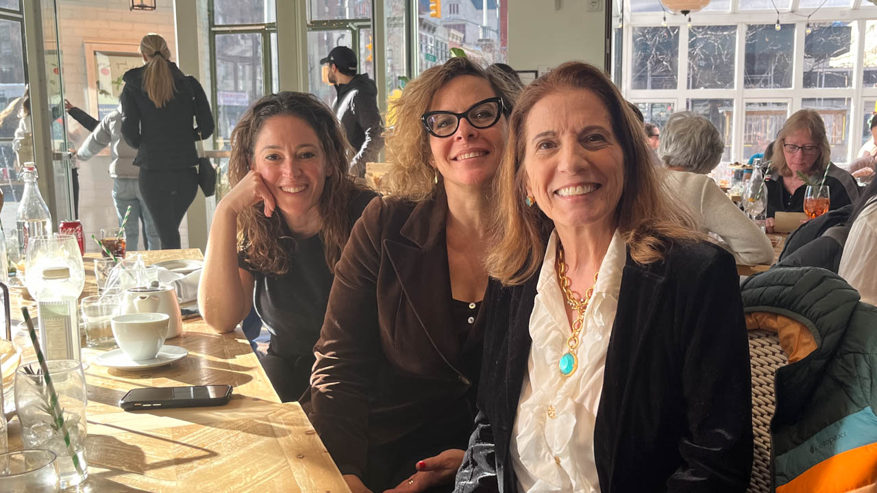 group photo of three people at a restaurant
