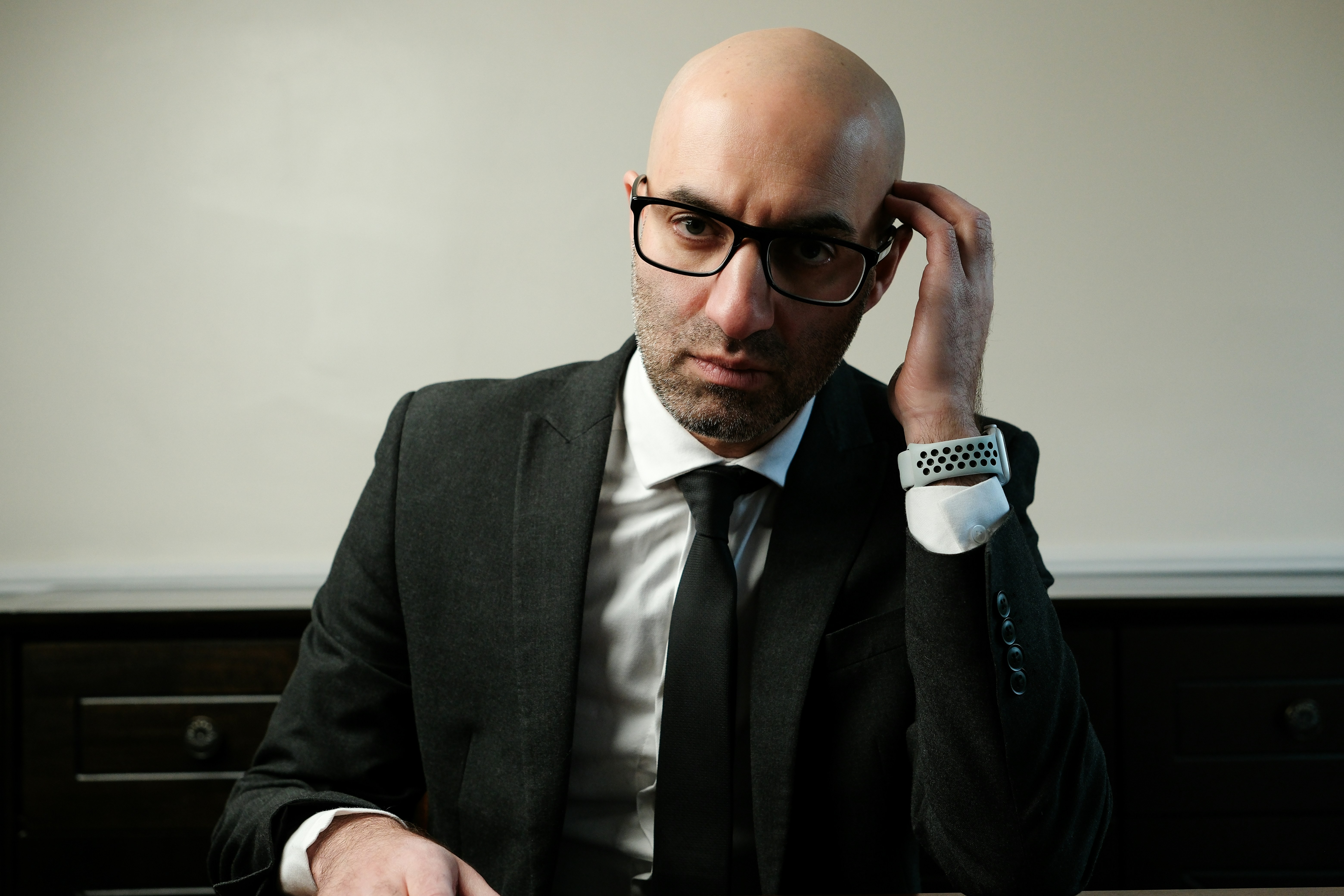 A man in a suit and tie sitting at a table