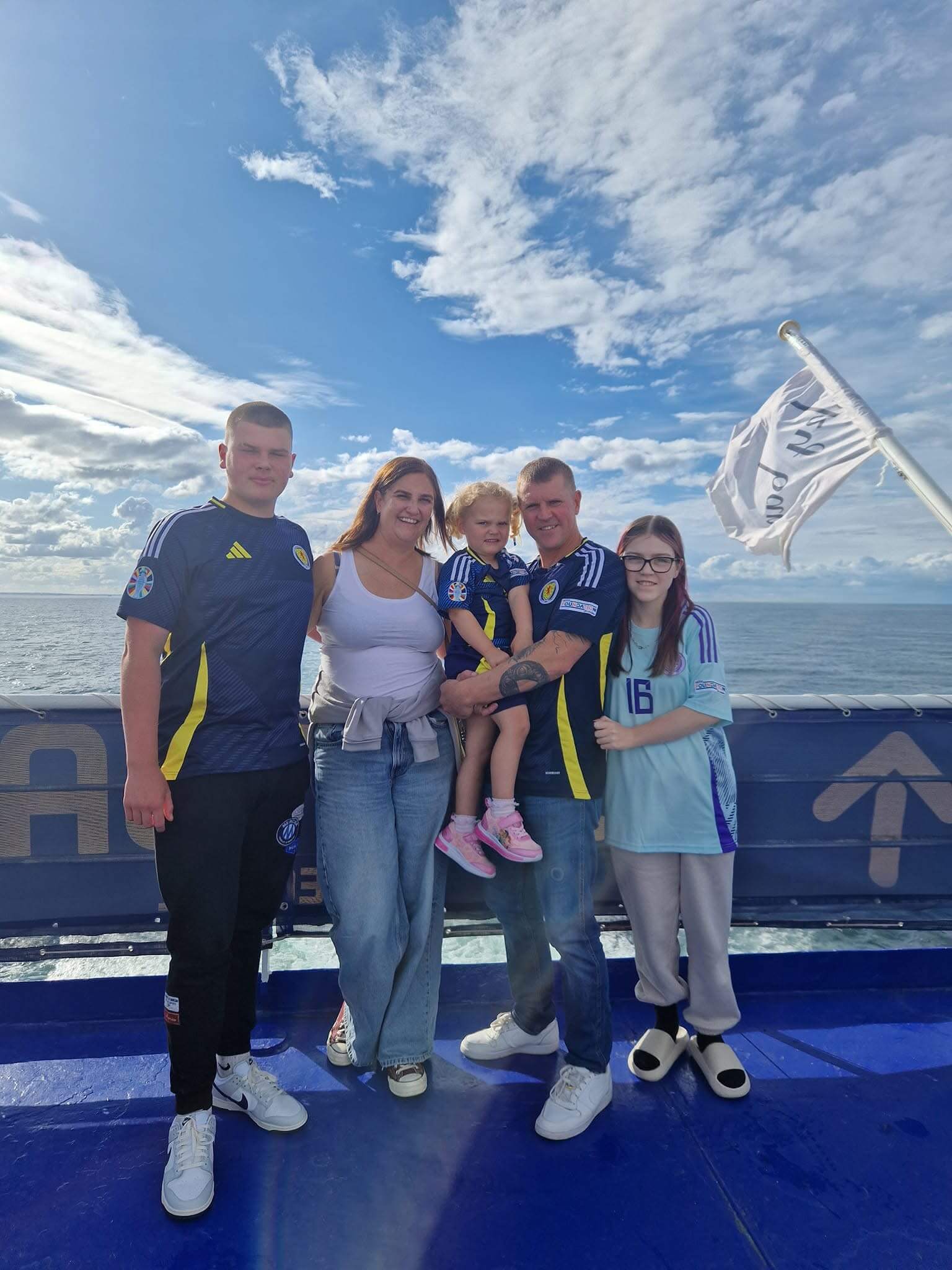 Steph with her family with a backdrop of the ocean