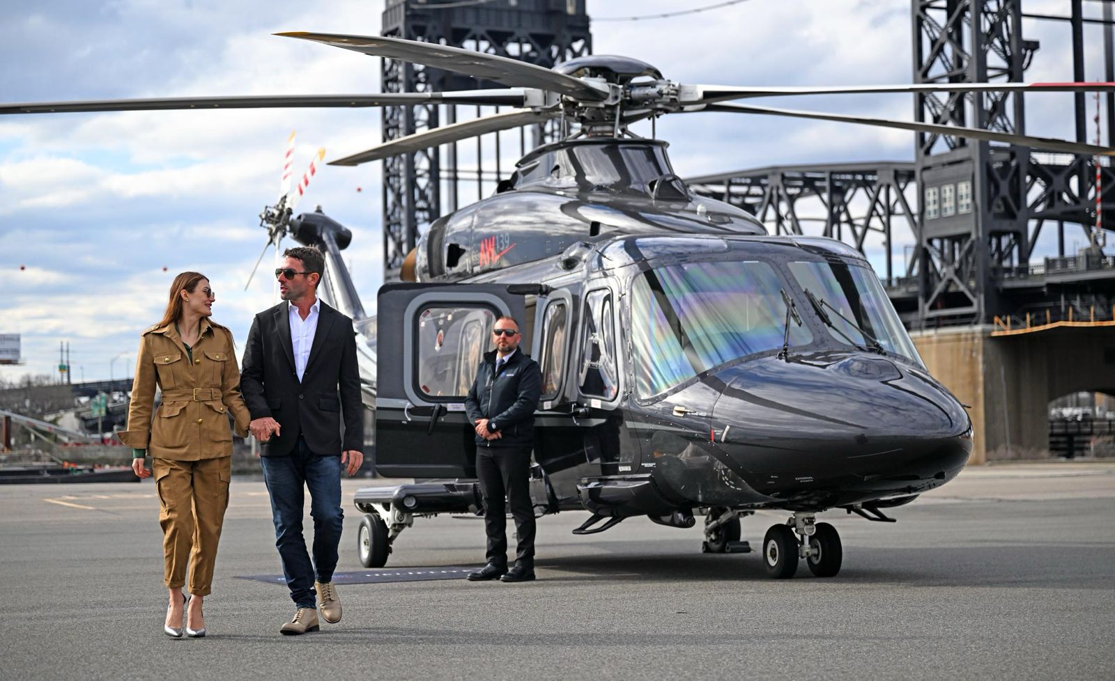 Couple exiting luxury helicopter at private landing site