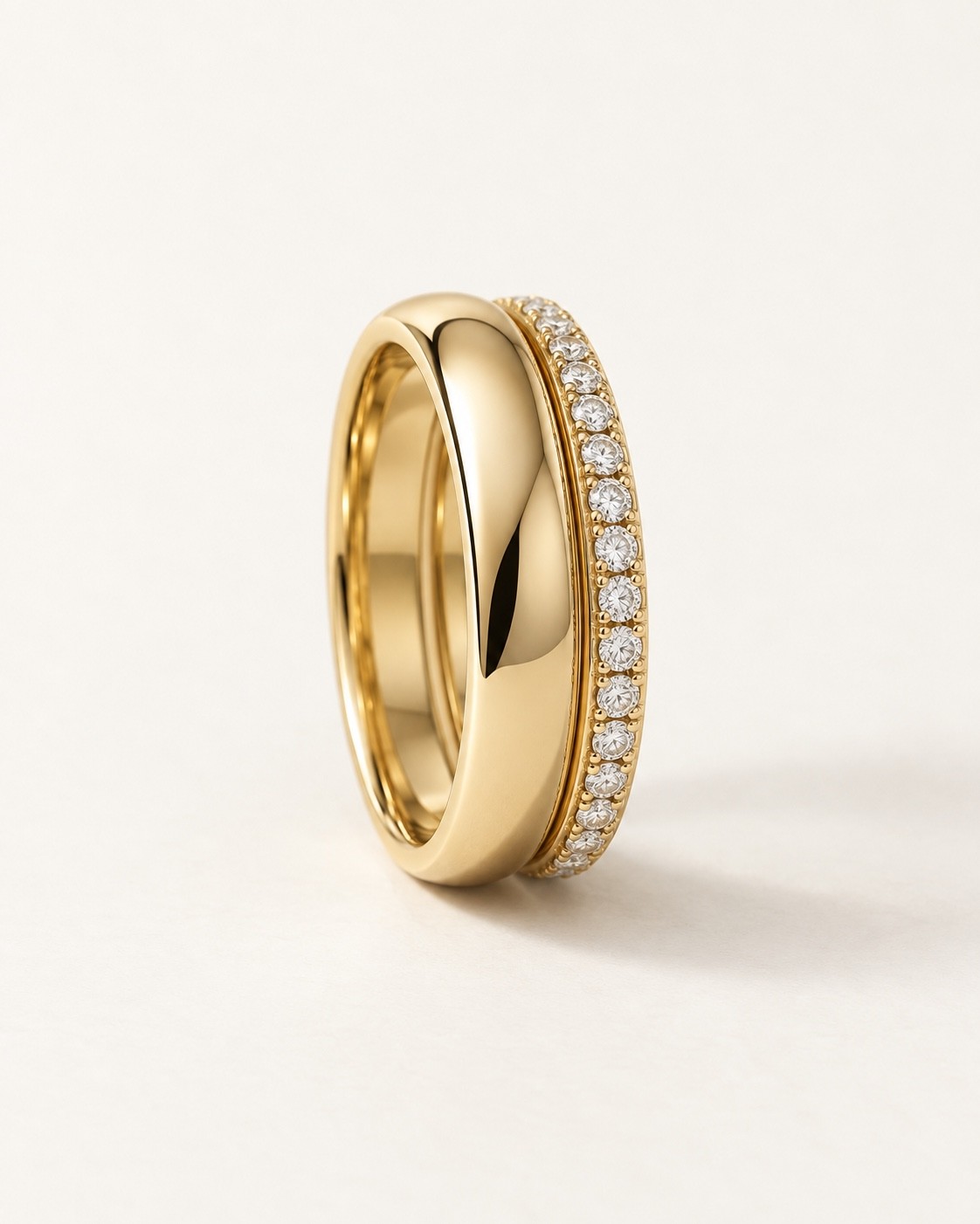 Polished gold band paired with a slim diamond-set band