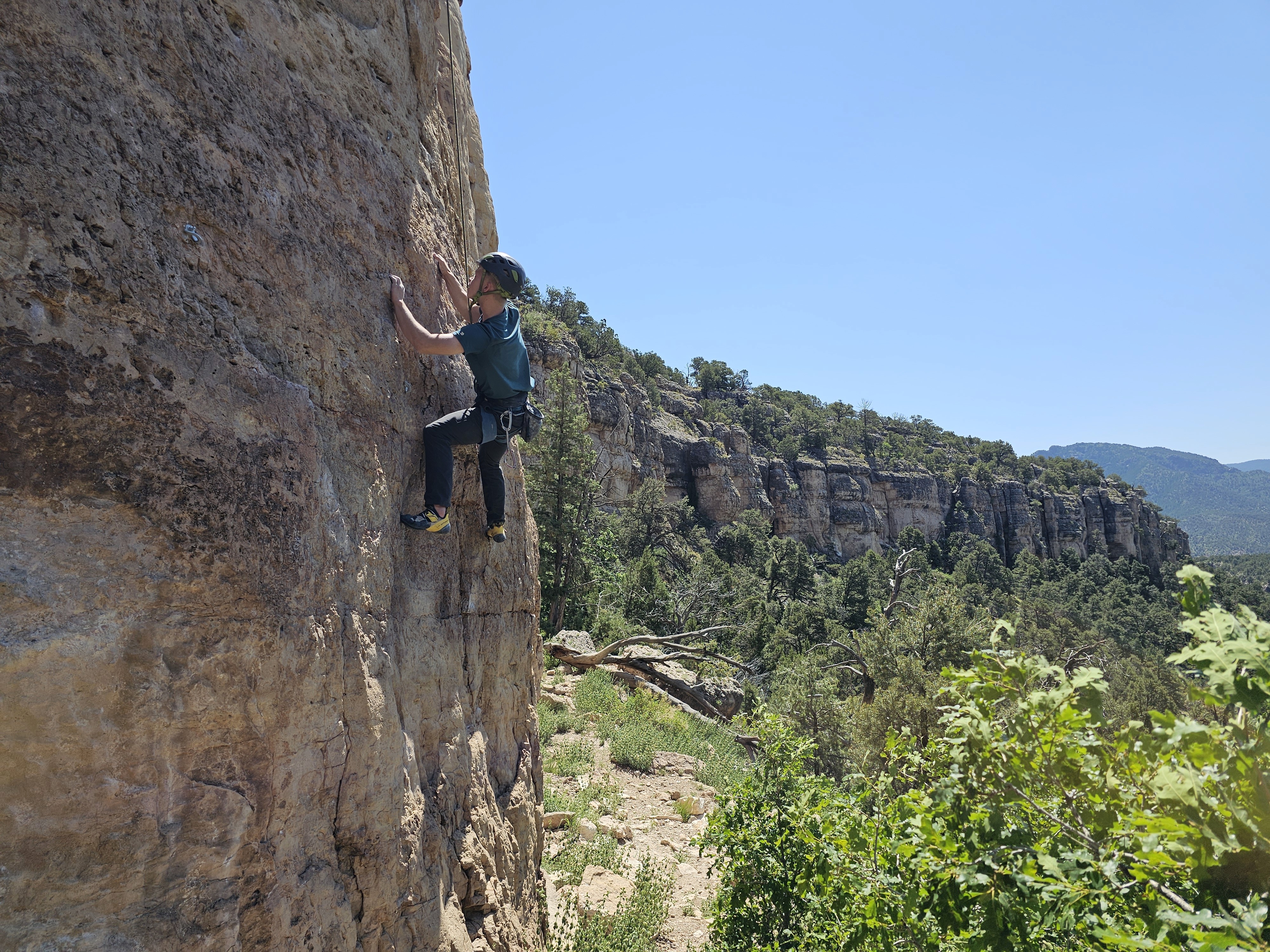 Climber searches for holds on a climbing trip at Shelf Road