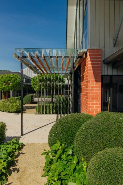 Garden walkway beside the brick and glass retreat centre building