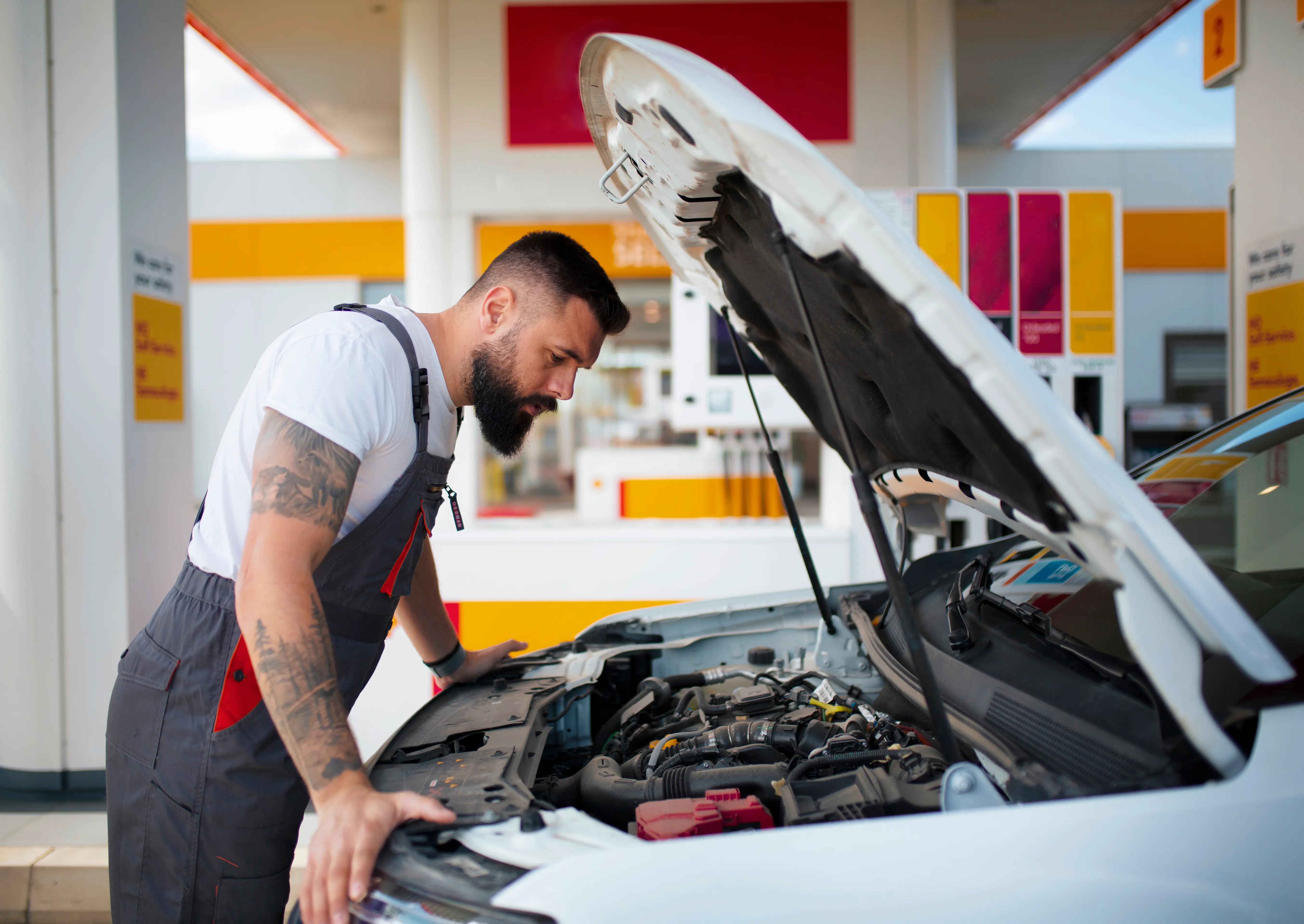 Man inspecting car engine.