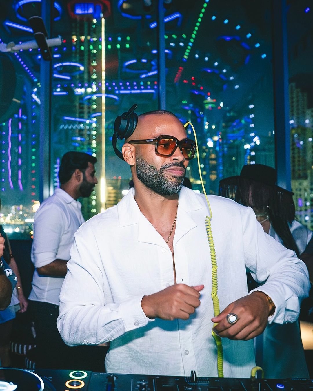 DJ booth with lighting and corporate event guests in Dubai managed by an entertainment agency Dubai.