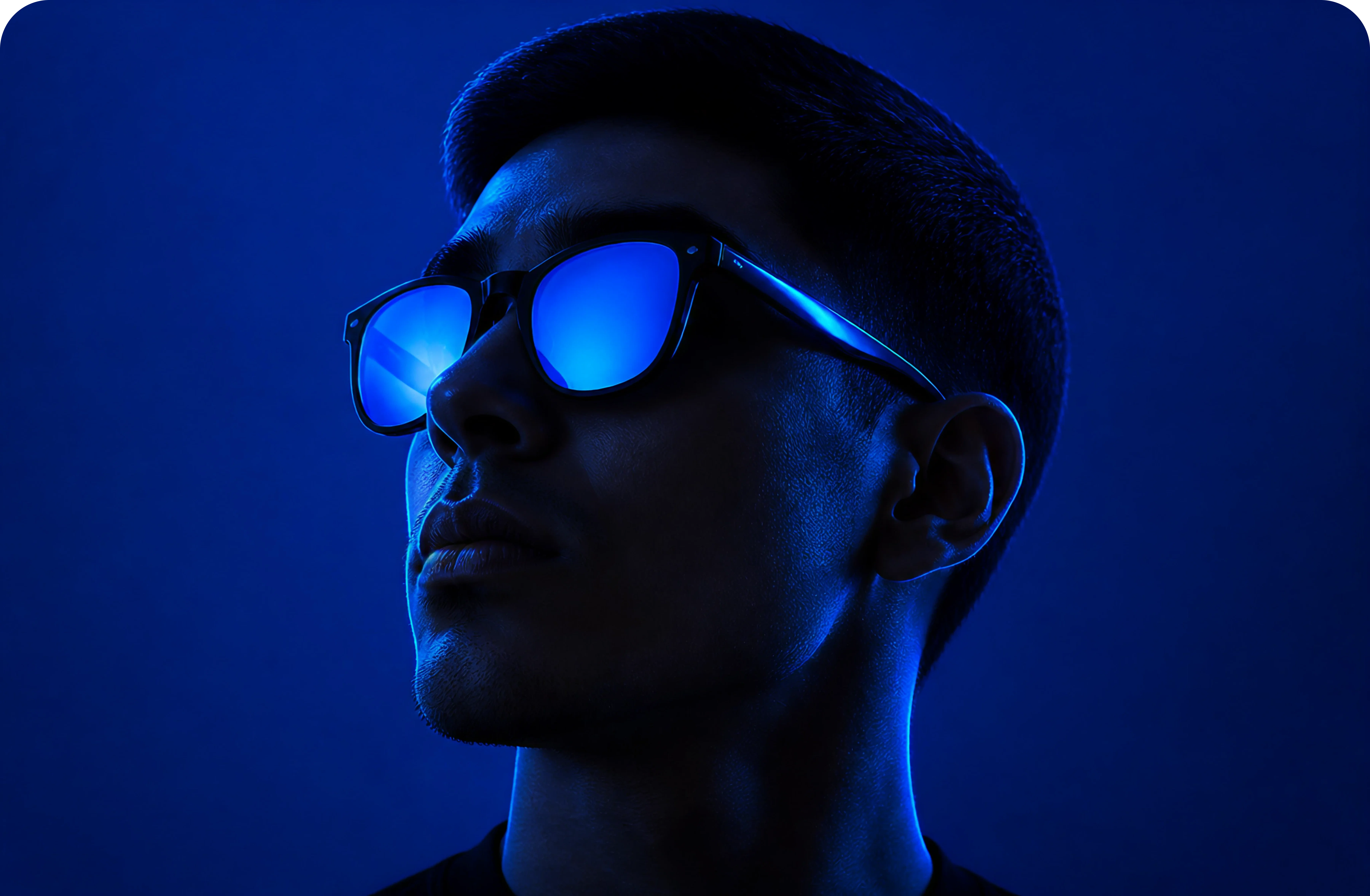 Silhouette of a person wearing red-orange sunglasses on orange.