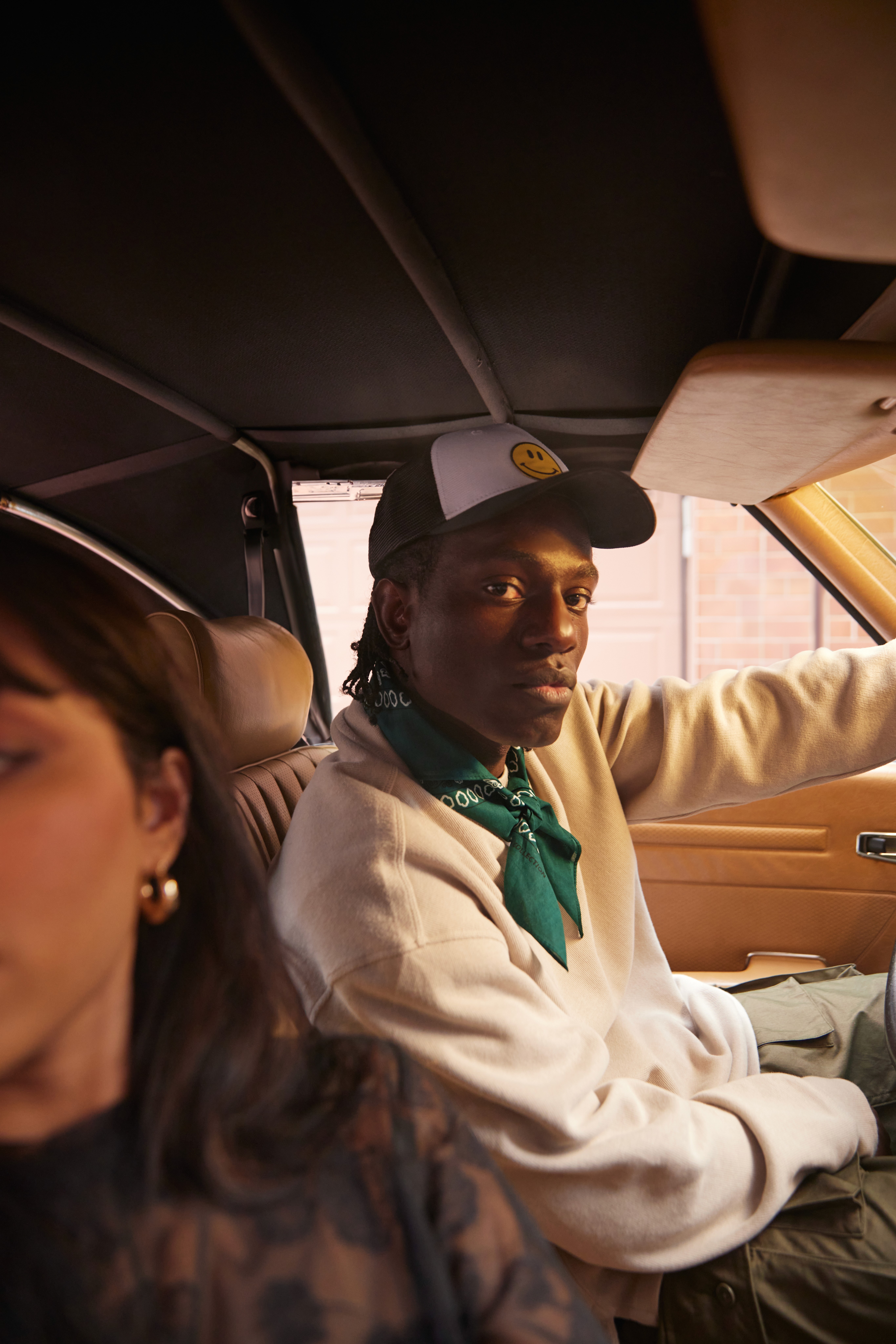 A tan sighthound stands in a grassy field.