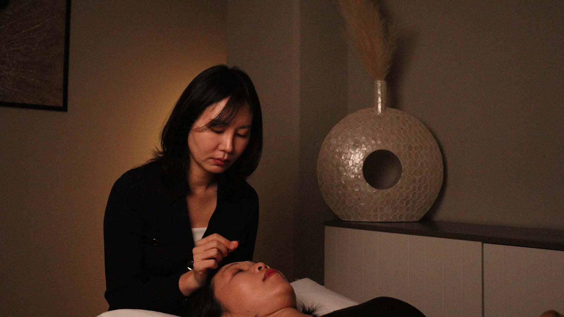 Patient getting face acupuncture.