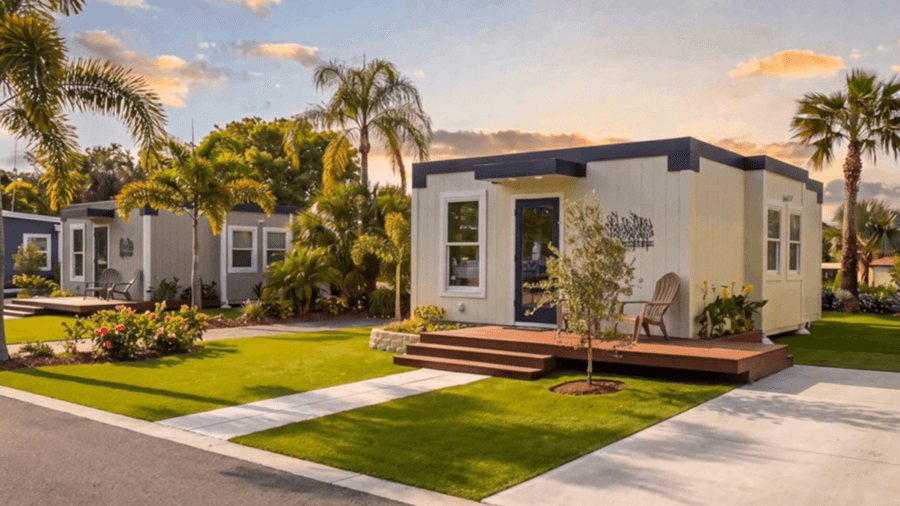 Exterior view of a compact modern ADU with flat roof and landscaped backyard with sun