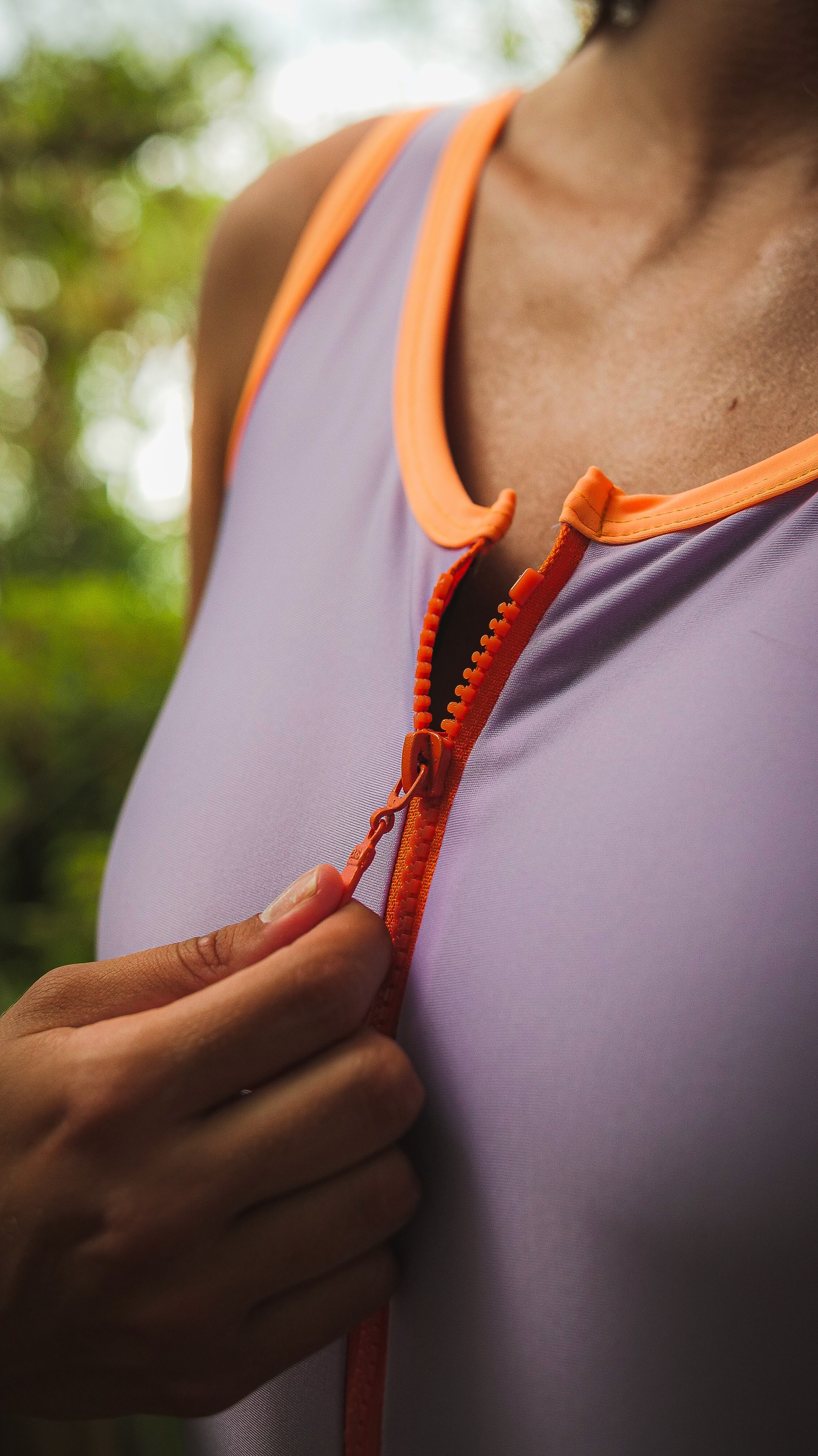 A close-up of a person wearing green-tinted glasses, with a serious expression and smooth skin.