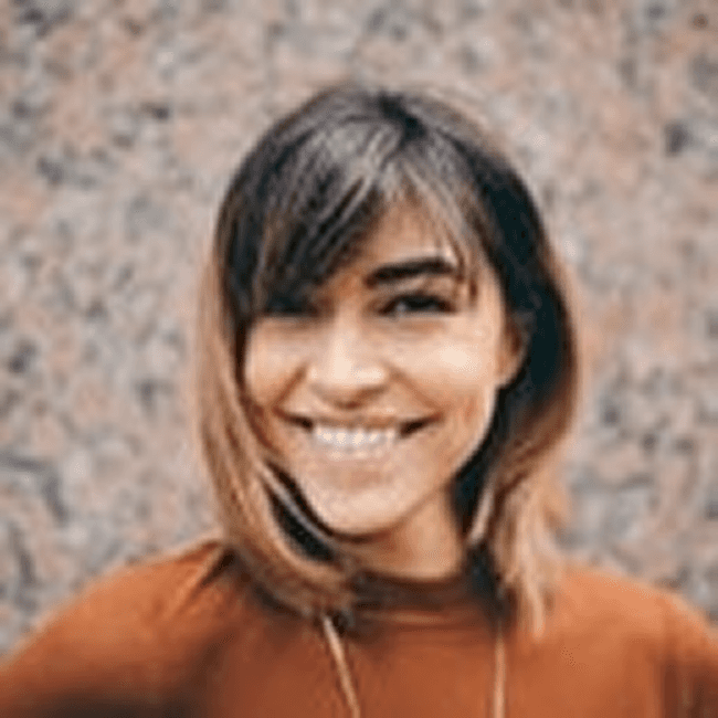 smiling woman wearing white and black pinstriped collared top