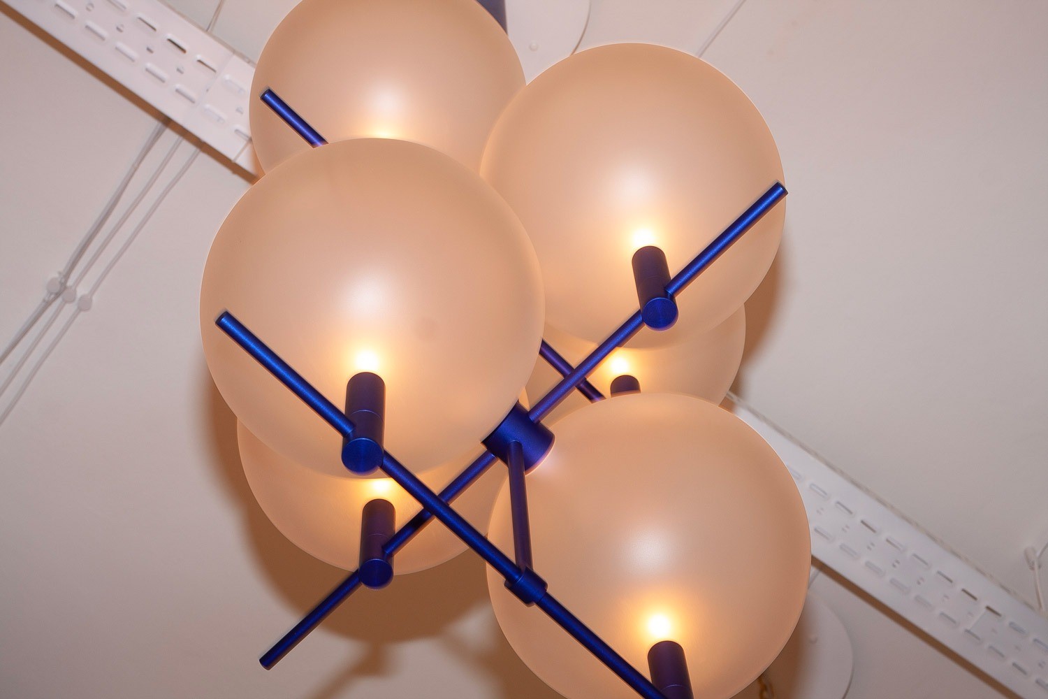 Close-up of Luna II vertical luminaire showing metal structural frame and architectural joints by Jiri Krejcirik