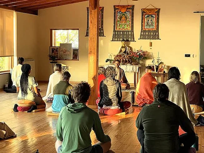 Silent meditation retreat with multiple daily sessions, Hridaya yoga, lectures and vegan meals in a mountain setting.