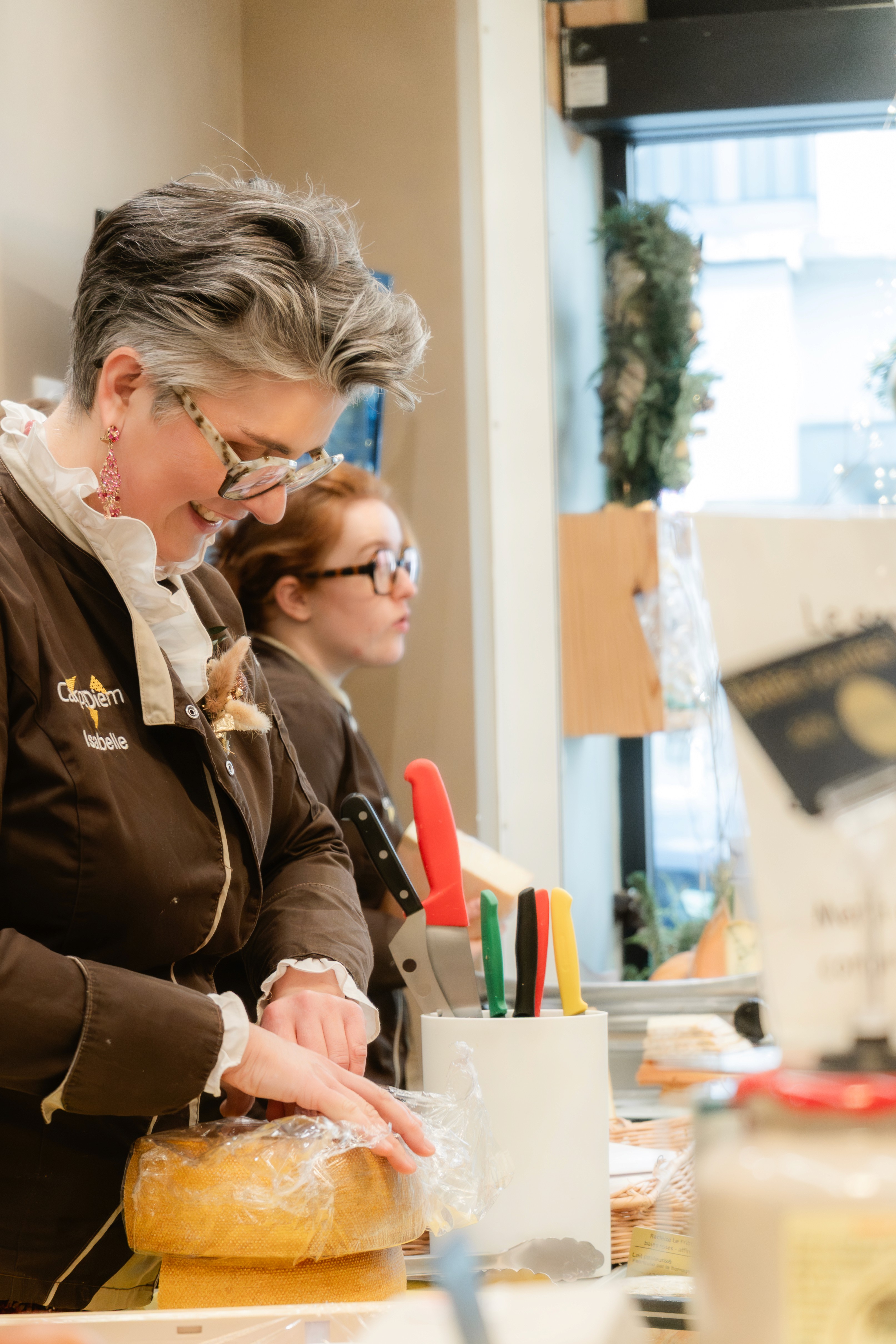 Woman in a beige turtleneck by an old computer and TV, retro 80s office portrait.