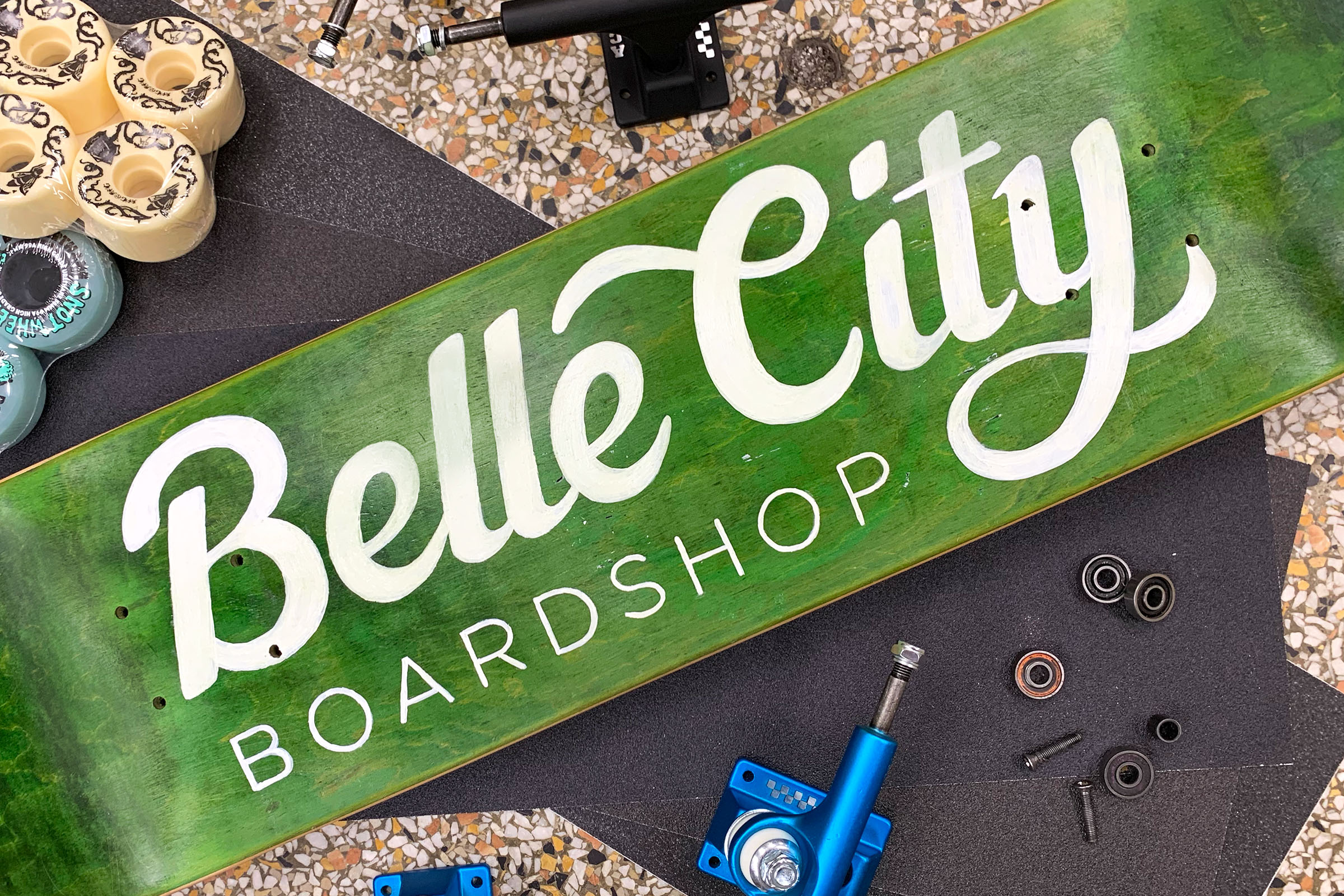 Painted skateboard that reads Belle City Boardshop