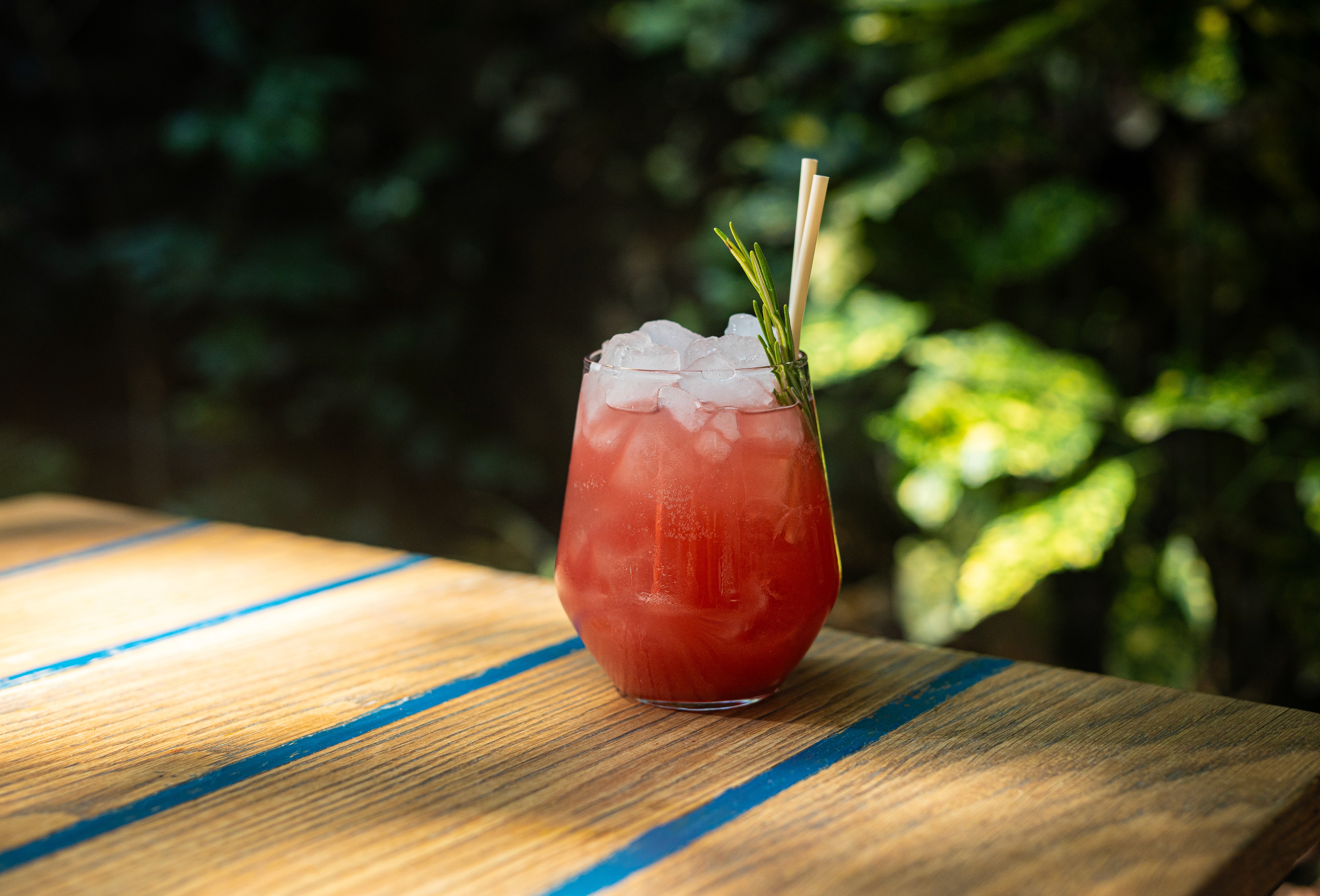 Cocktail with pink hue and garnish