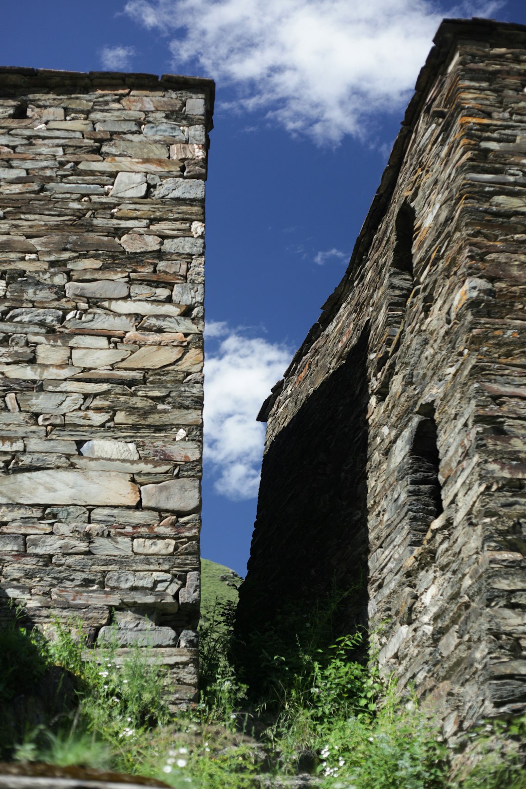 A couple of stone buildings sitting next to each other