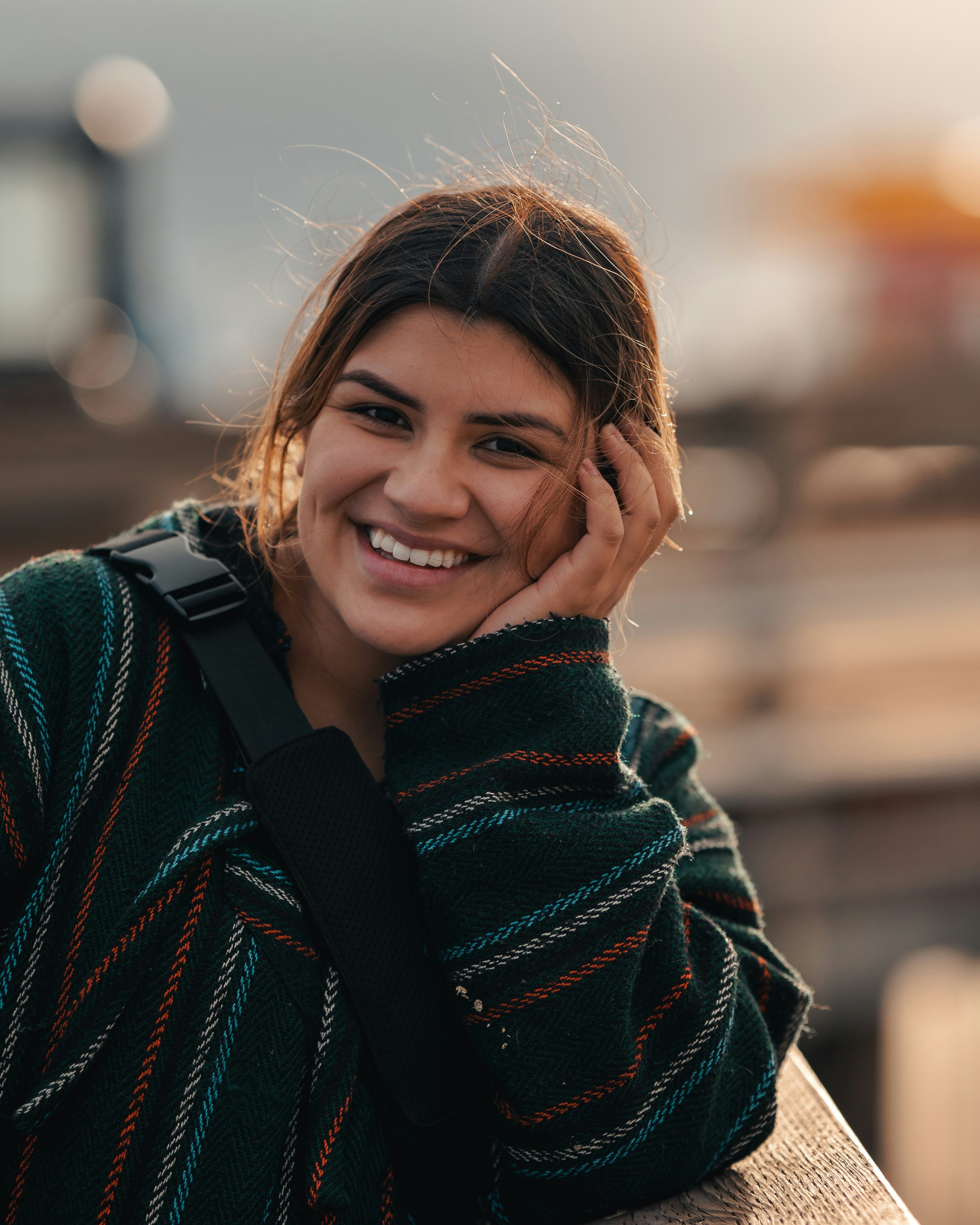smiling woman in blue and red scarf