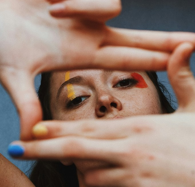 Person framing their face with their hands