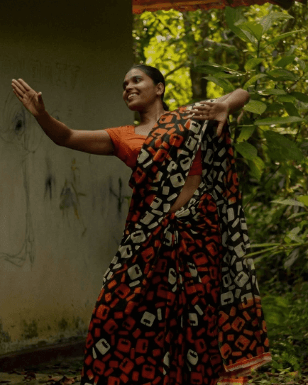 a group of women standing on top of a sandy beach