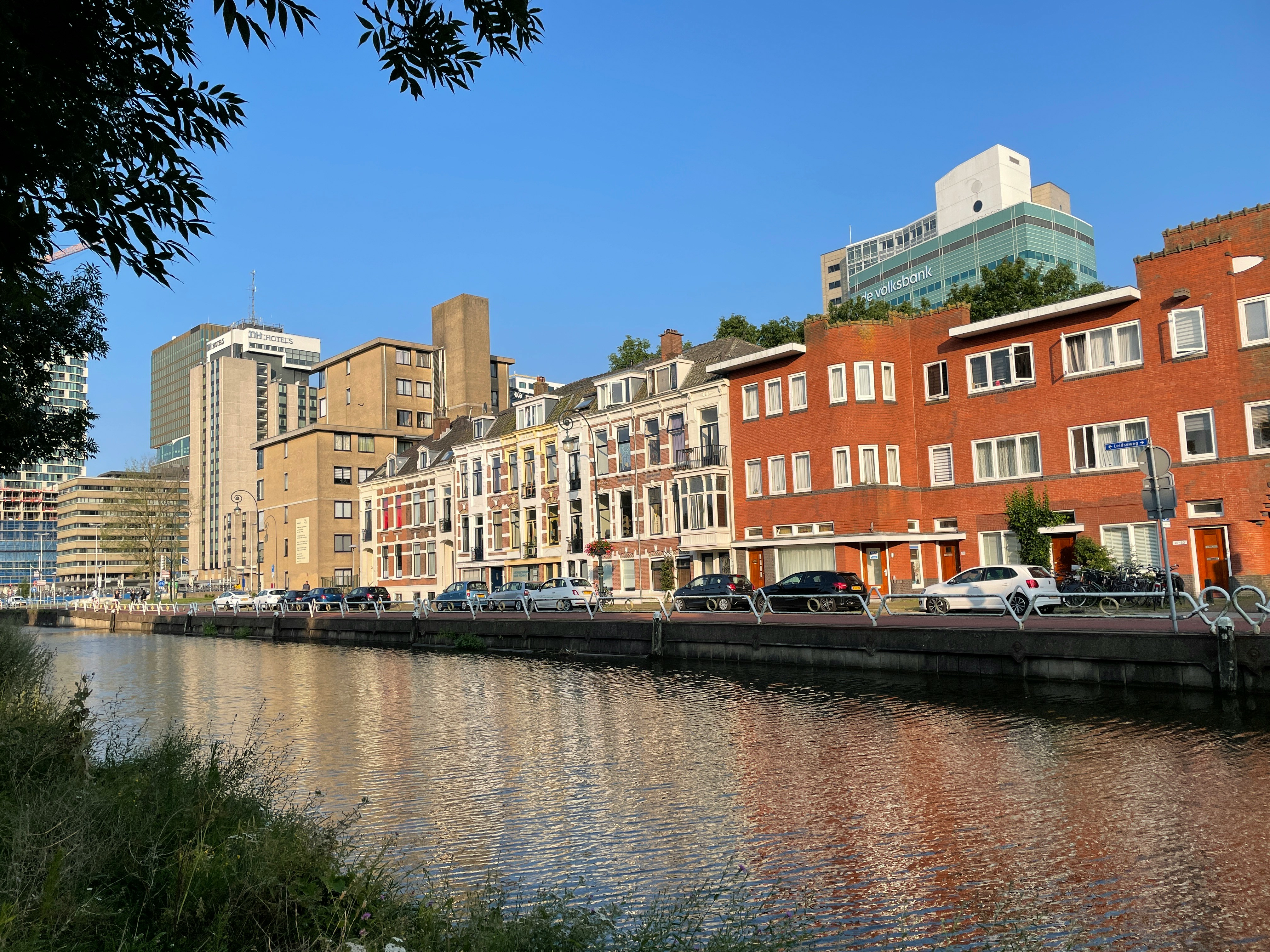 a river running through a city next to tall buildings