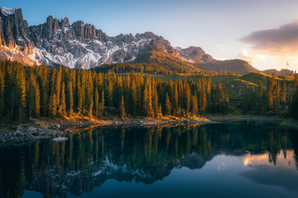 A lake surrounded by trees at sunset