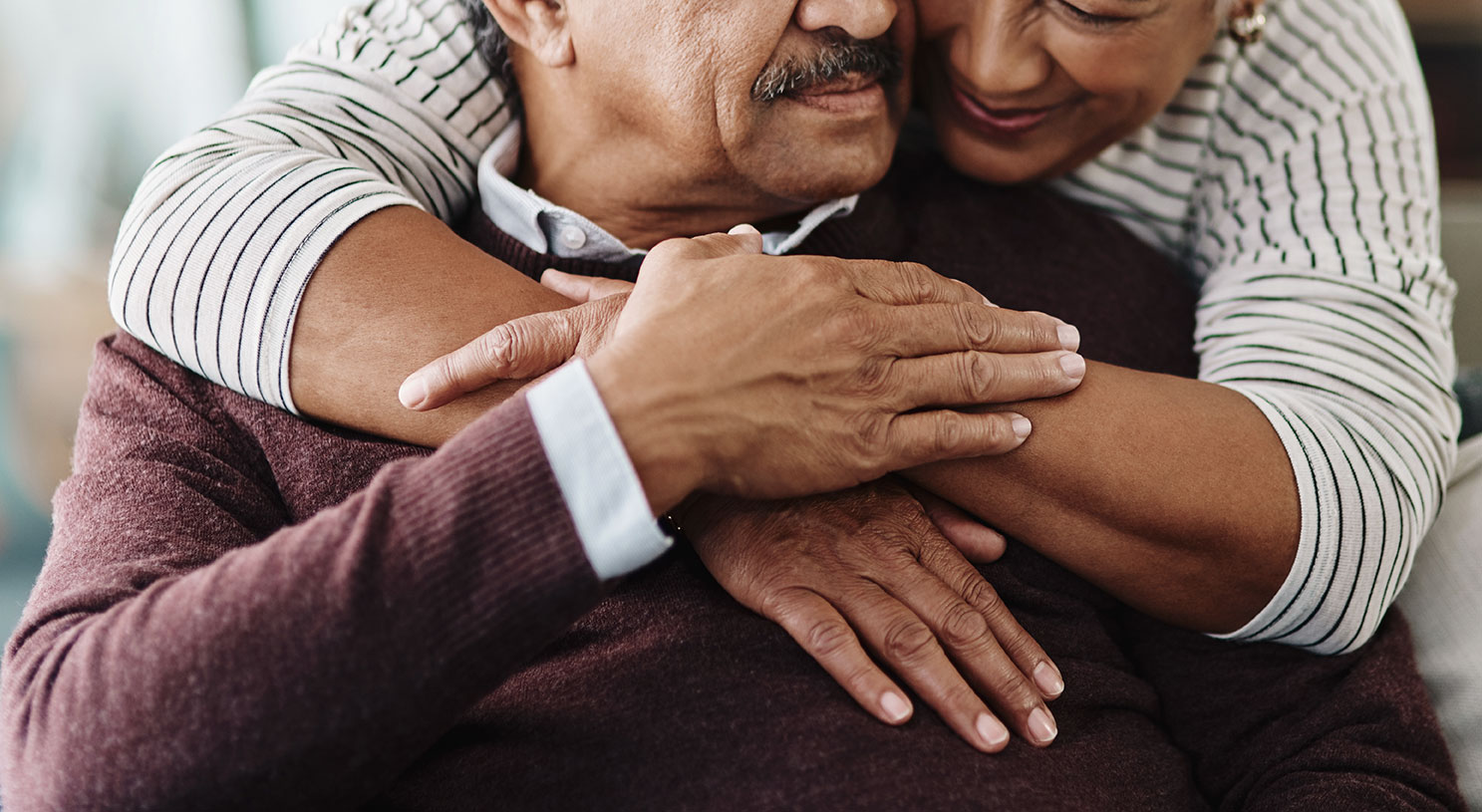 Two Elders embracing one another