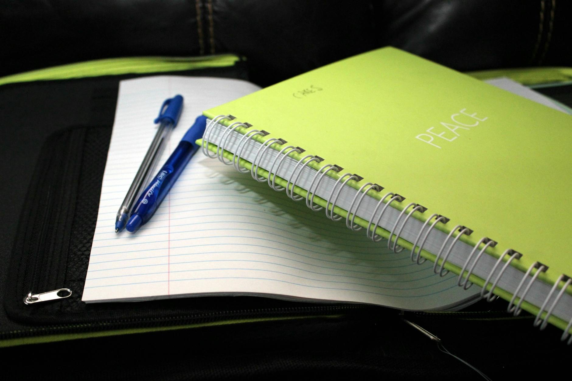 Close-up of a student writing ideas in a notebook during the individual reflection phase of think pair share.