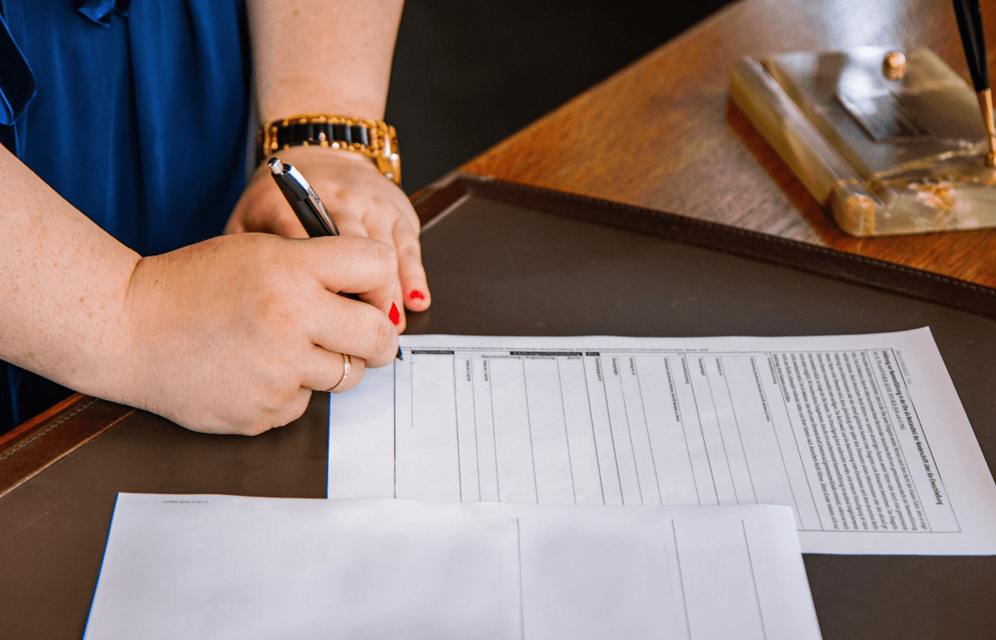 woman signing a document