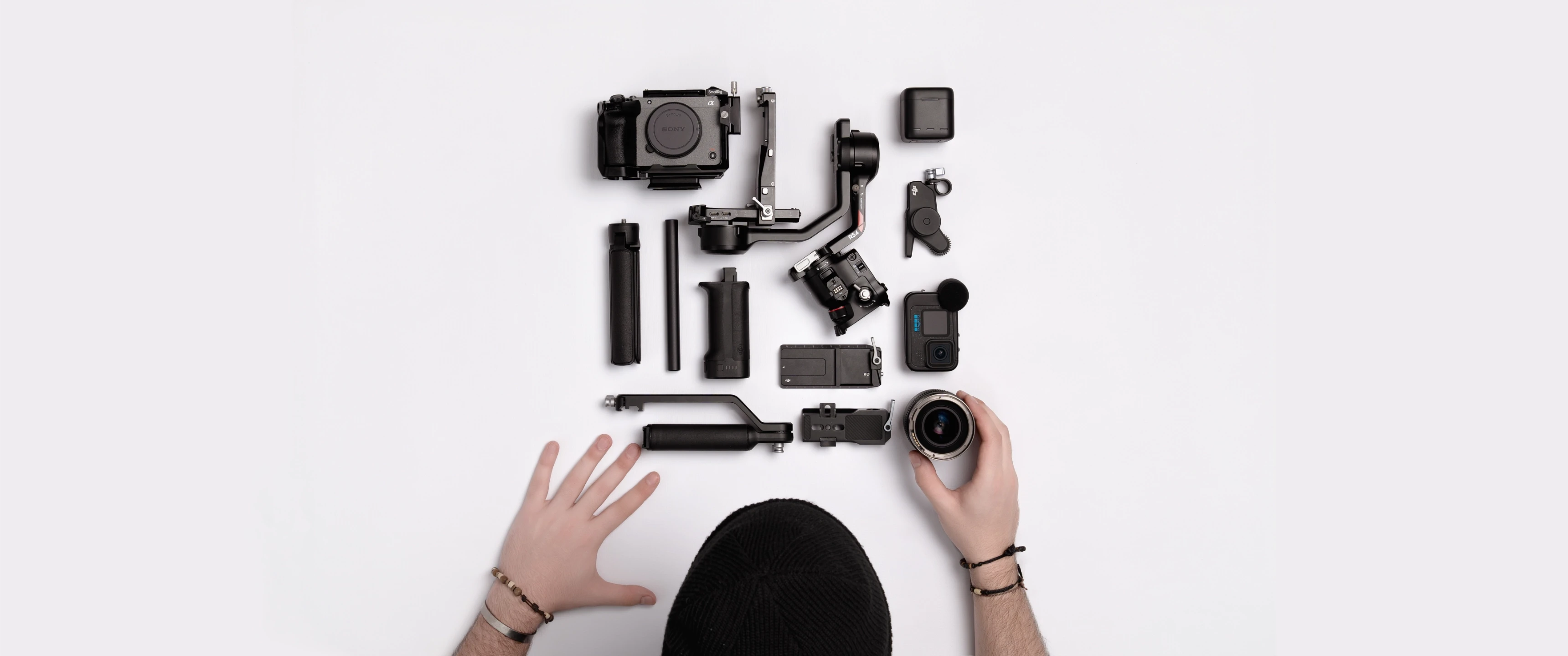Close-up of videography setup on a desk featuring camera gear and stabiliser alongside documents, representing Raybrand Media’s professional video production workflow, content creation process and creative studio environment