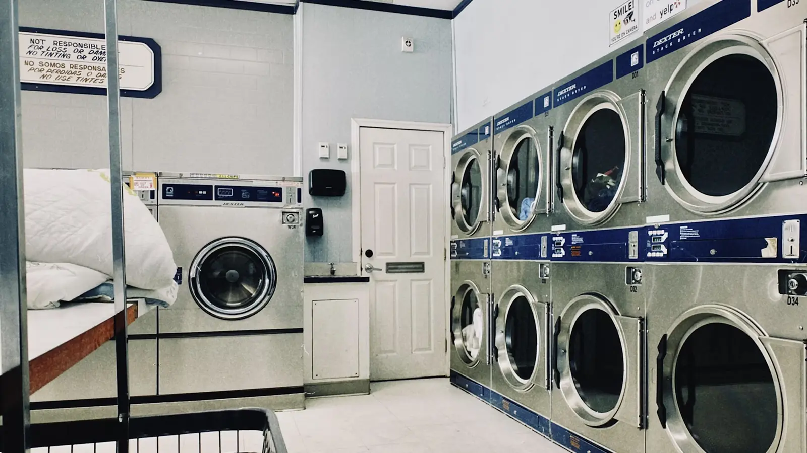 A row of washers and dryers in a laundry room