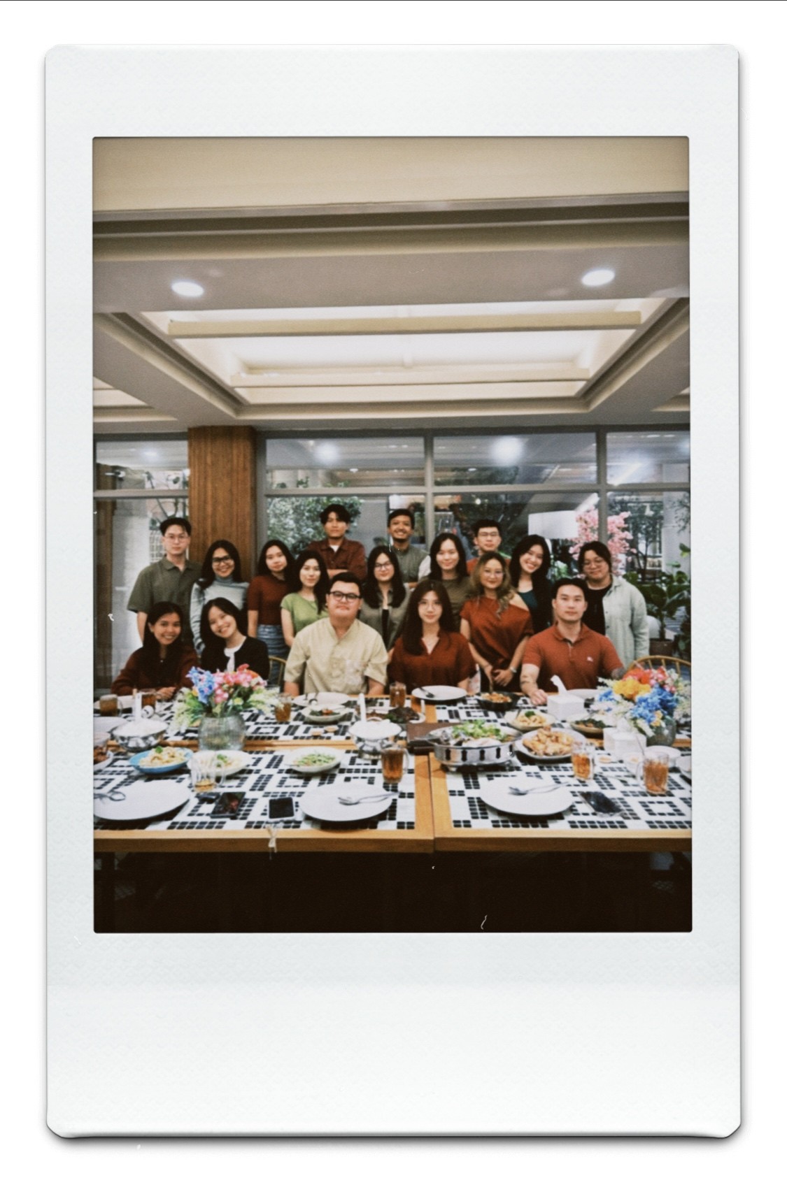 People playing soccer on a rooftop court surrounded by city buildings