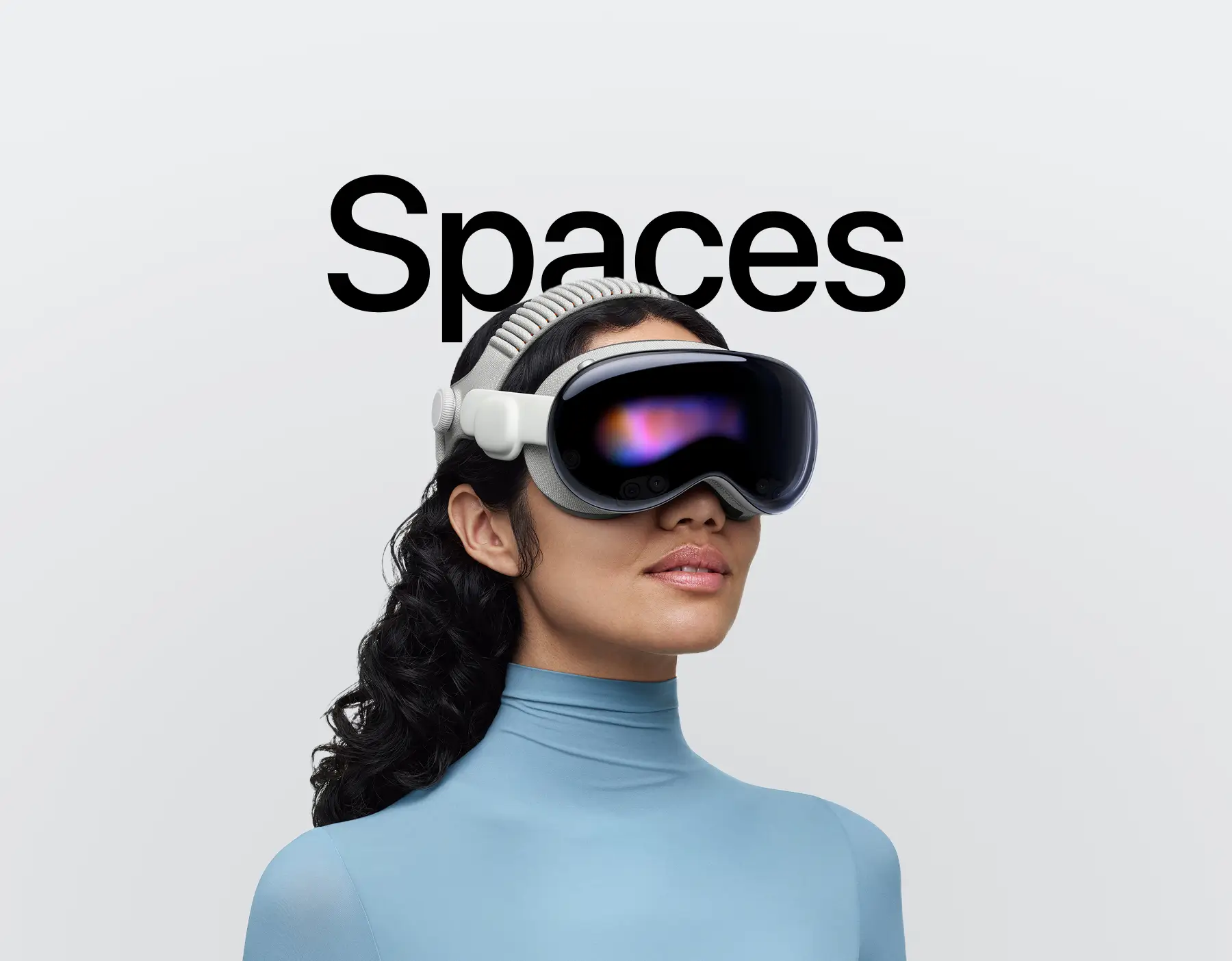 Women wearing Vision pro and "Spaces" text behind her 