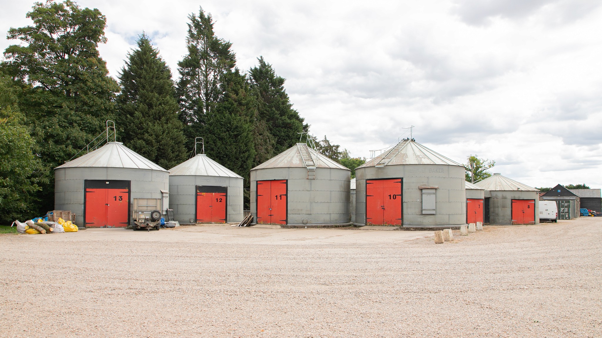 Two classic volkswagen beetles, one green, one cream.