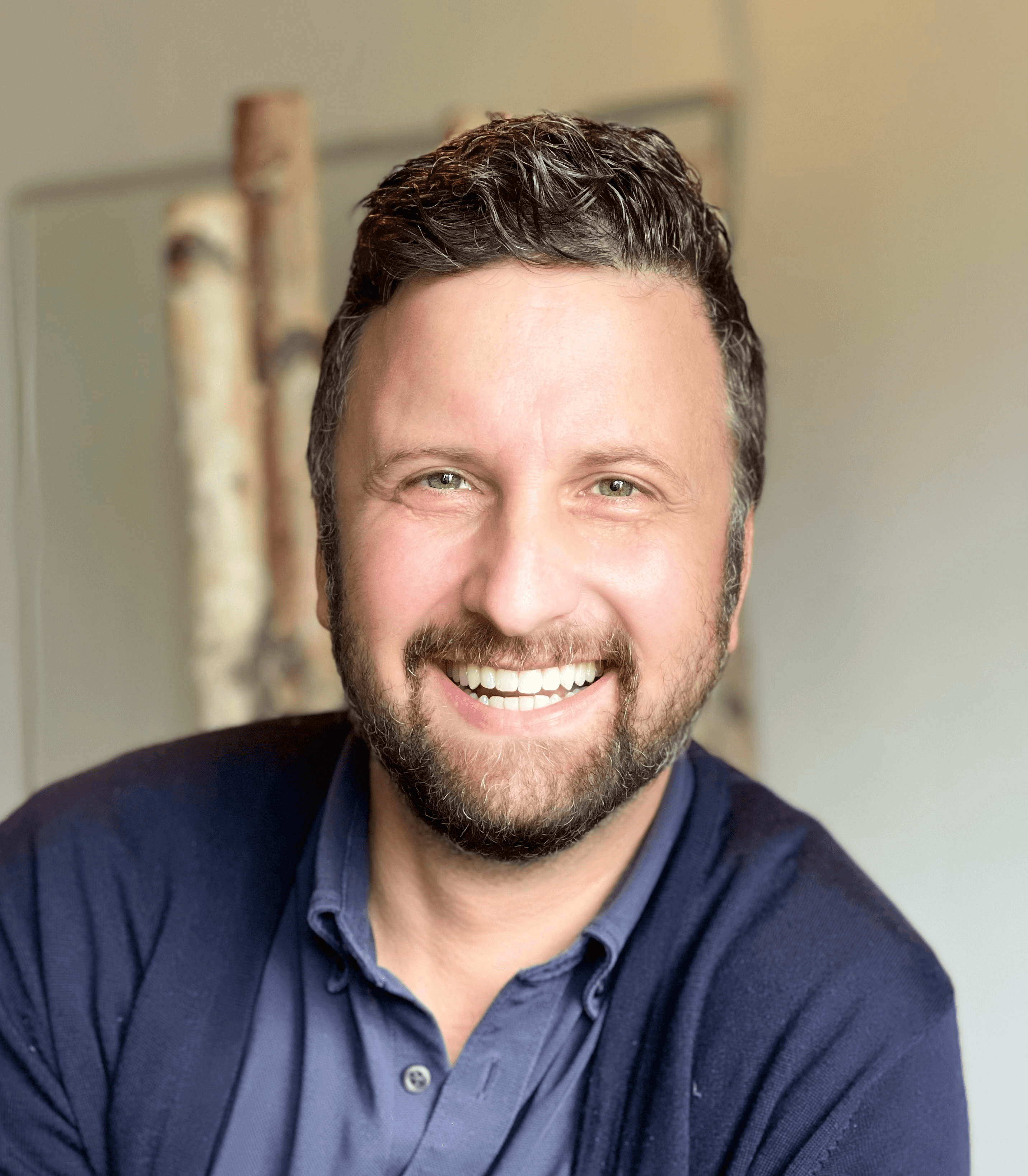 a man with a beard and a blue shirt