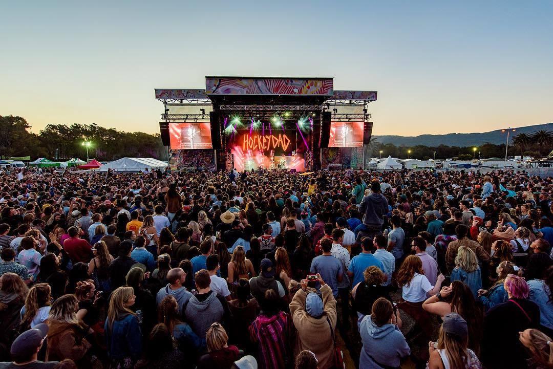 Concert audience facing a lit stage