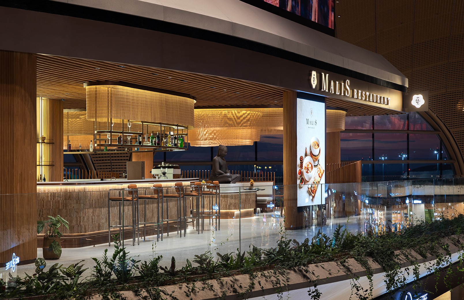The bar and lounge area at golden hour showcasing the integration of architectural lighting and panoramic views of the airport apron designed to maximize operational atmosphere and guest retention