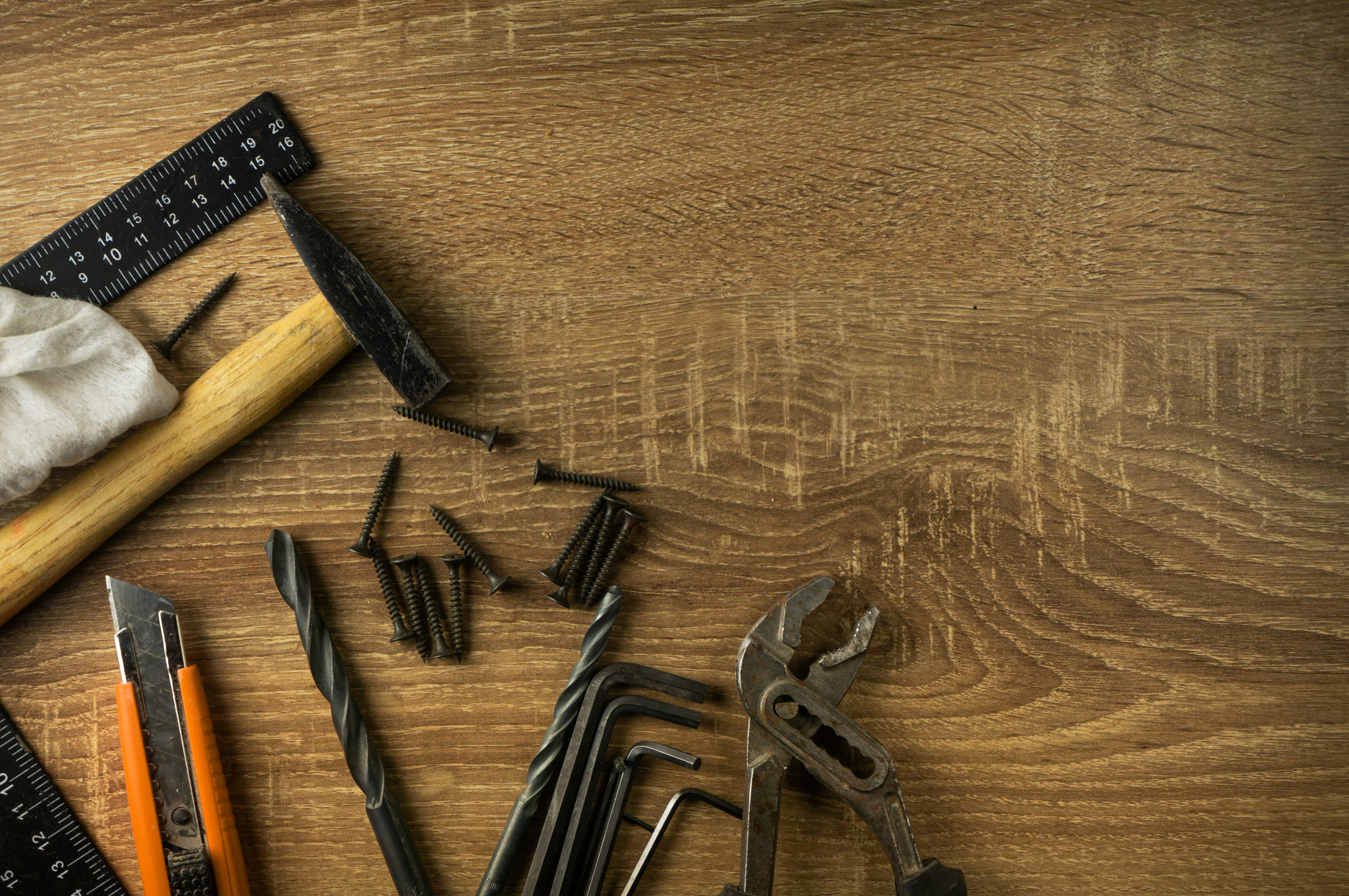 Hand tools and a measuring square on a wooden bench